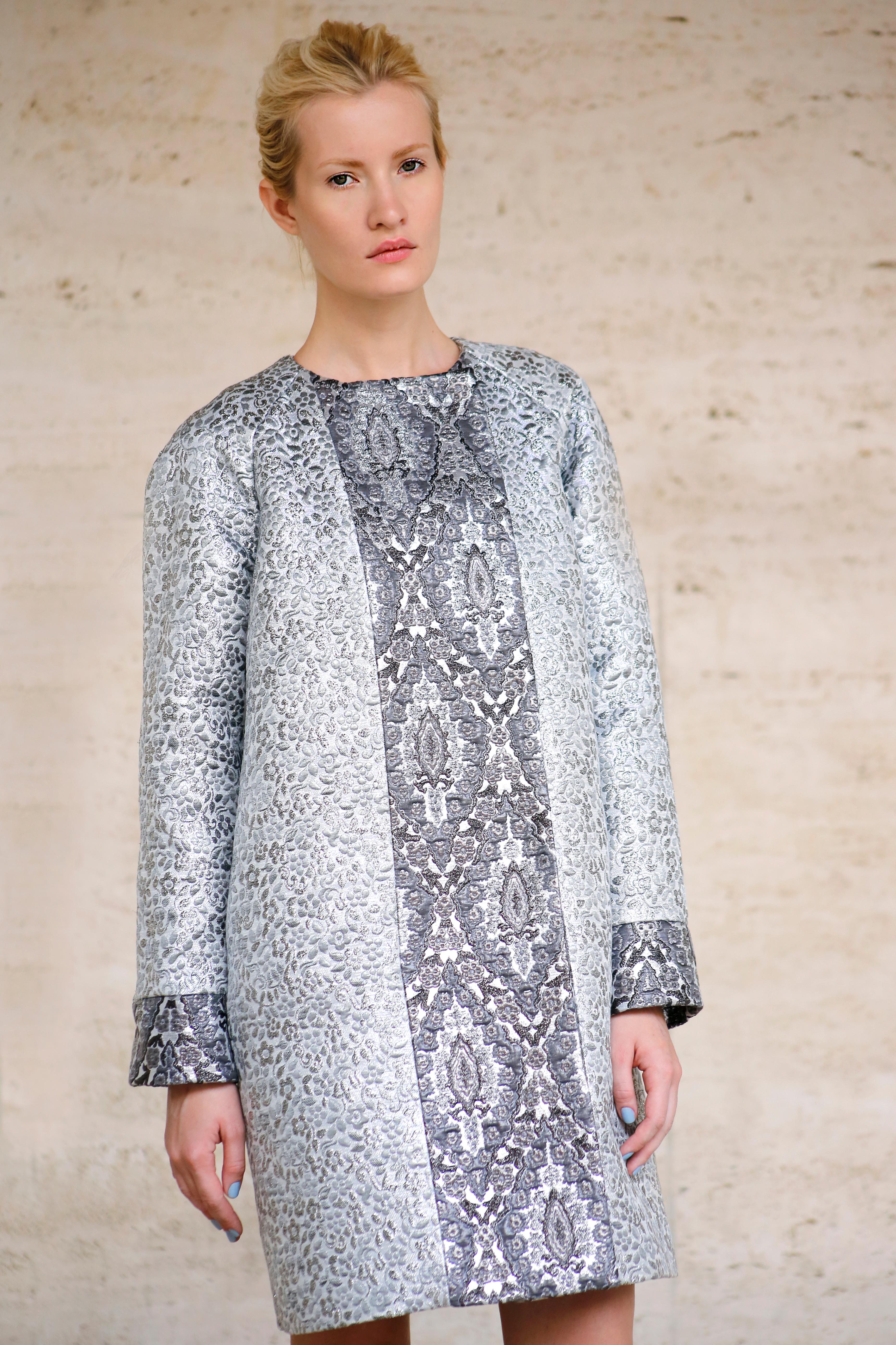 The Elise Pelush silver brocade coat is a one of a kind exclusive piece. Featuring a rare Italian Haute Couture metallic brocade fabrics in Damask and floral cloque' emboss, this fabulous fashion statement coat has iridescent opaline threads