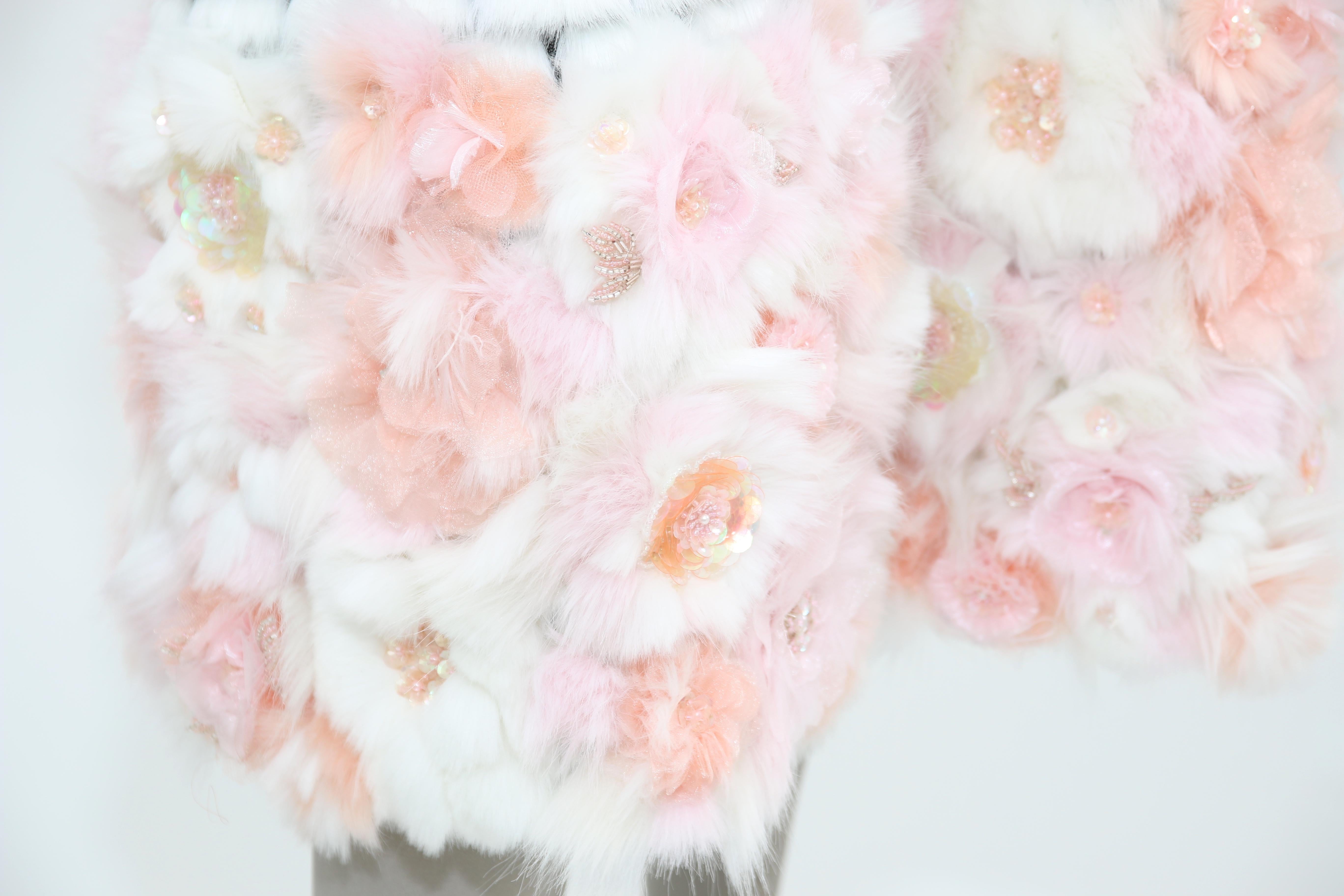 The Eva Pelush white Couture faux fur mink coat with three dimensional flowers is a one of a kind exclusive Couture piece. Featuring the best man made pelage, this extraordinary striking fur free coat is a beautiful replica of the mink, fox and