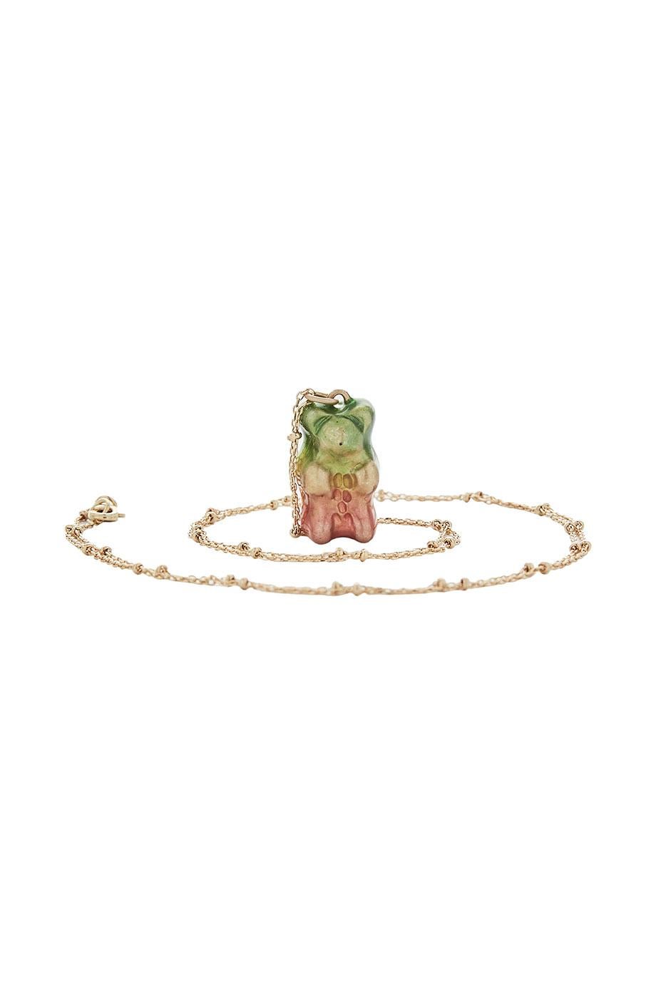 Watermelon Gummy bear 

18K gold plated silver gummy bear pendant on silver gold plated chain with transparent green yellow and pink enamel coverage. 

The Gummy Project by Maggoosh is a capsule collection inspired by the designer's life in New York