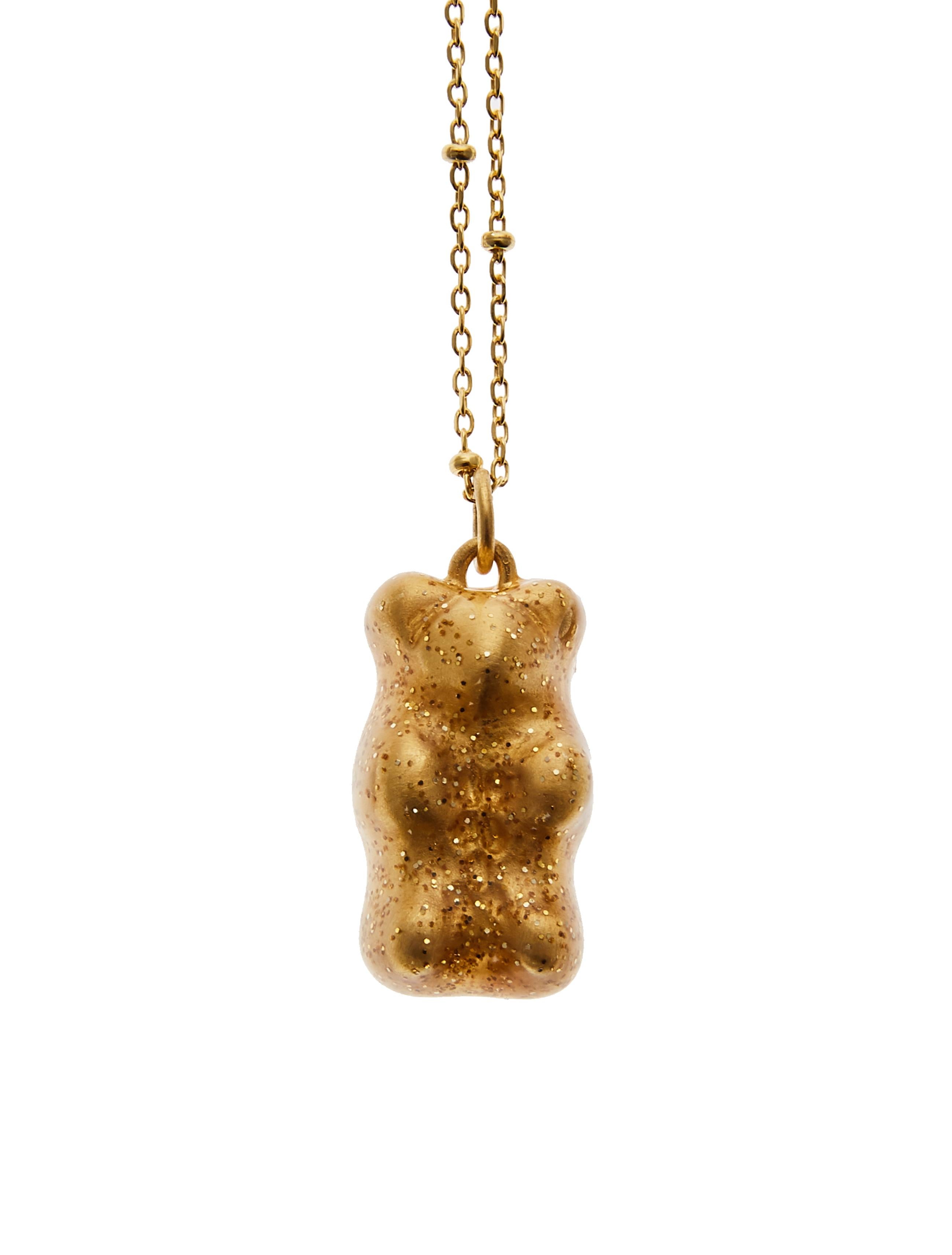 Holiday Gummy bear 

18K gold plated silver gummy bear pendant on silver gold plated chain with transparent yellow with glitter enamel coverage. 

The Gummy Project by Maggoosh is a capsule collection inspired by the designer's life in New York City