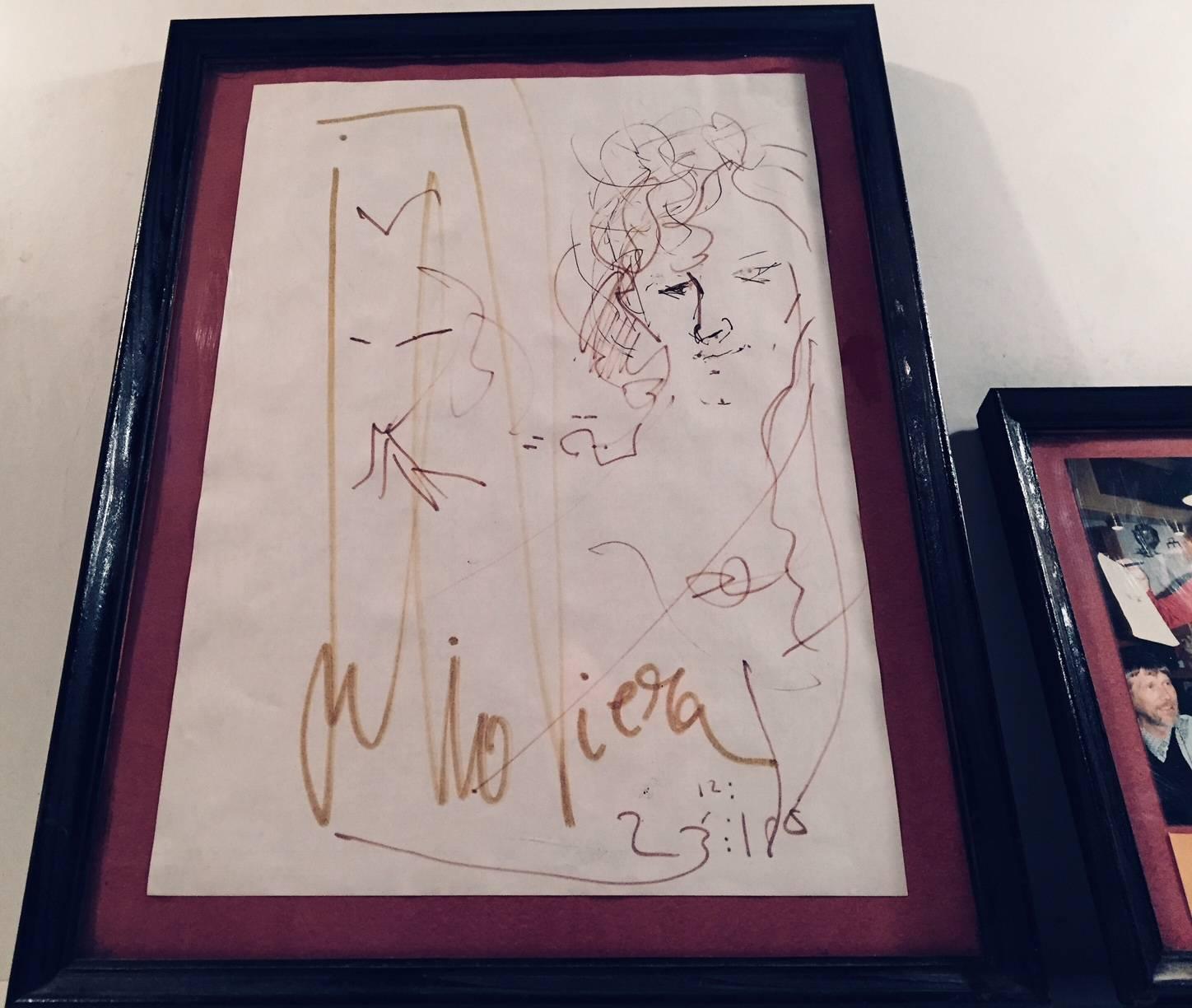 Julio Viera made this drawing depicting a Danish tourist called Ruth. Ruth met and drank with Viera at Pepe's Bar in Mallorca, Spain. The drawing is accompanied by a photograph of Viera holding the drawing. The drawing is dated 23/12 - 1987 and the
