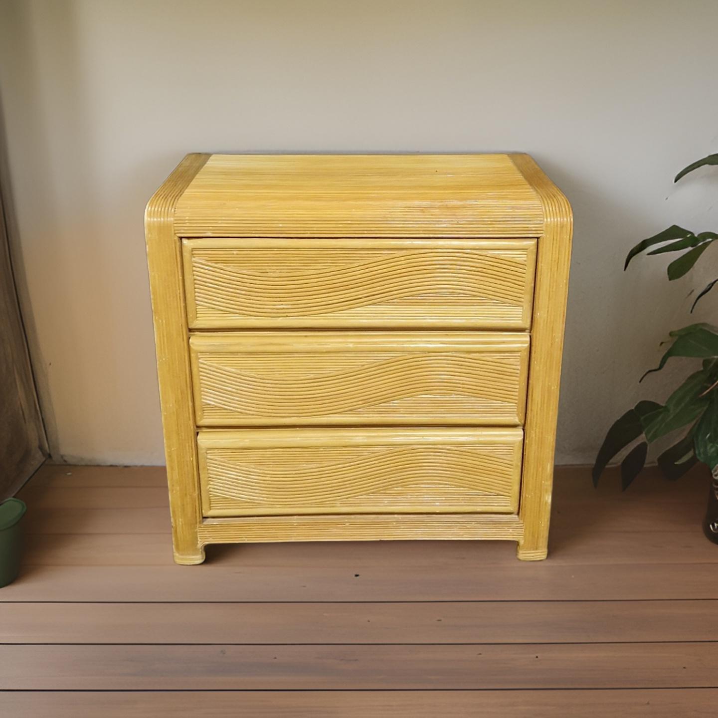 1970s chest of drawers. Made from wood and pencil reed. Sculptural design with beautiful waving decor on the drawer fronts. Made in Belgium by Rietshop Zonhoven, a reed weaver shop in Belgium. 
Skillfully made piece. The drawers have hidden handles