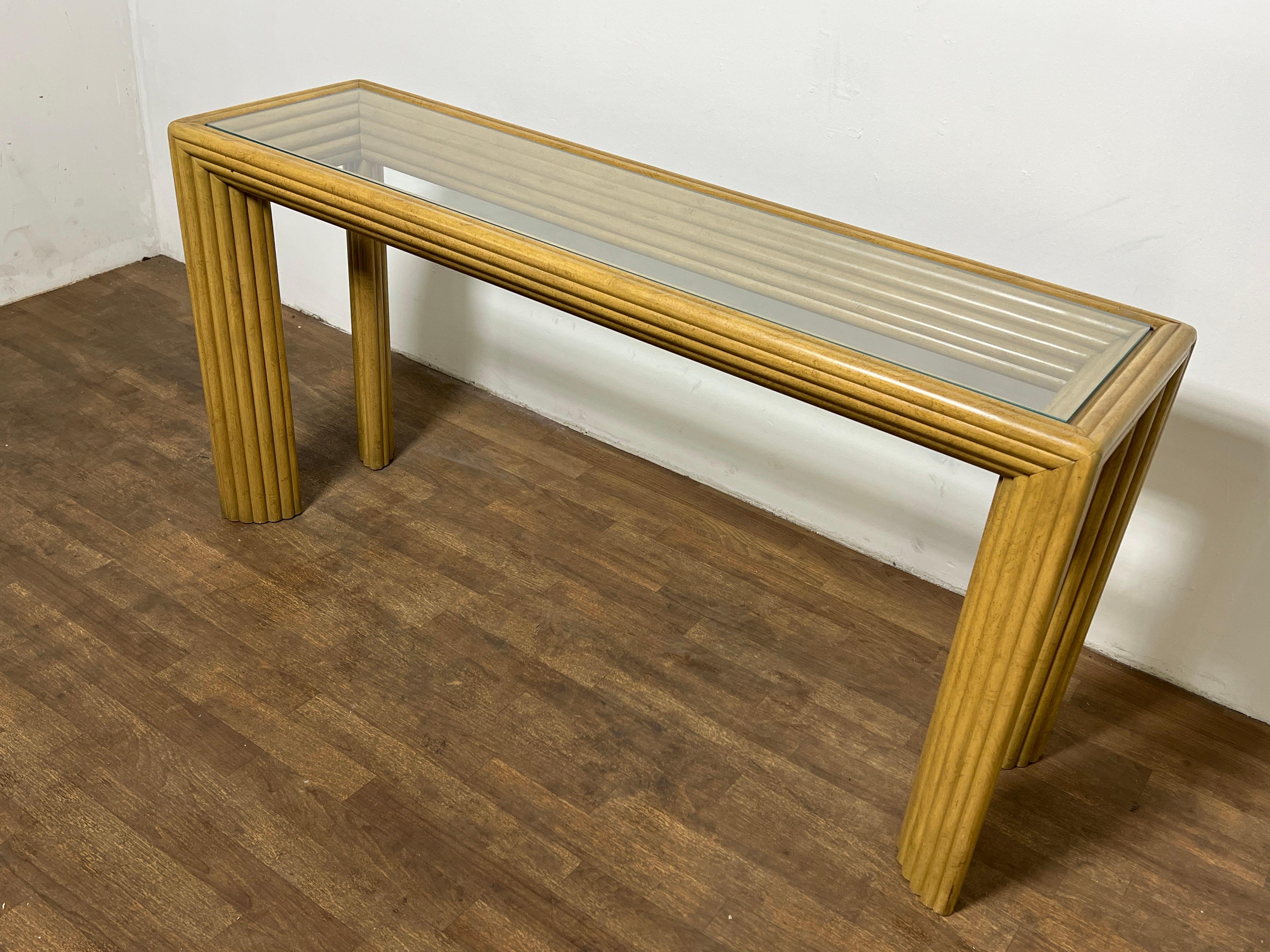 A post modern art deco style console table in wide pencil reed molding, ca. 1980s.