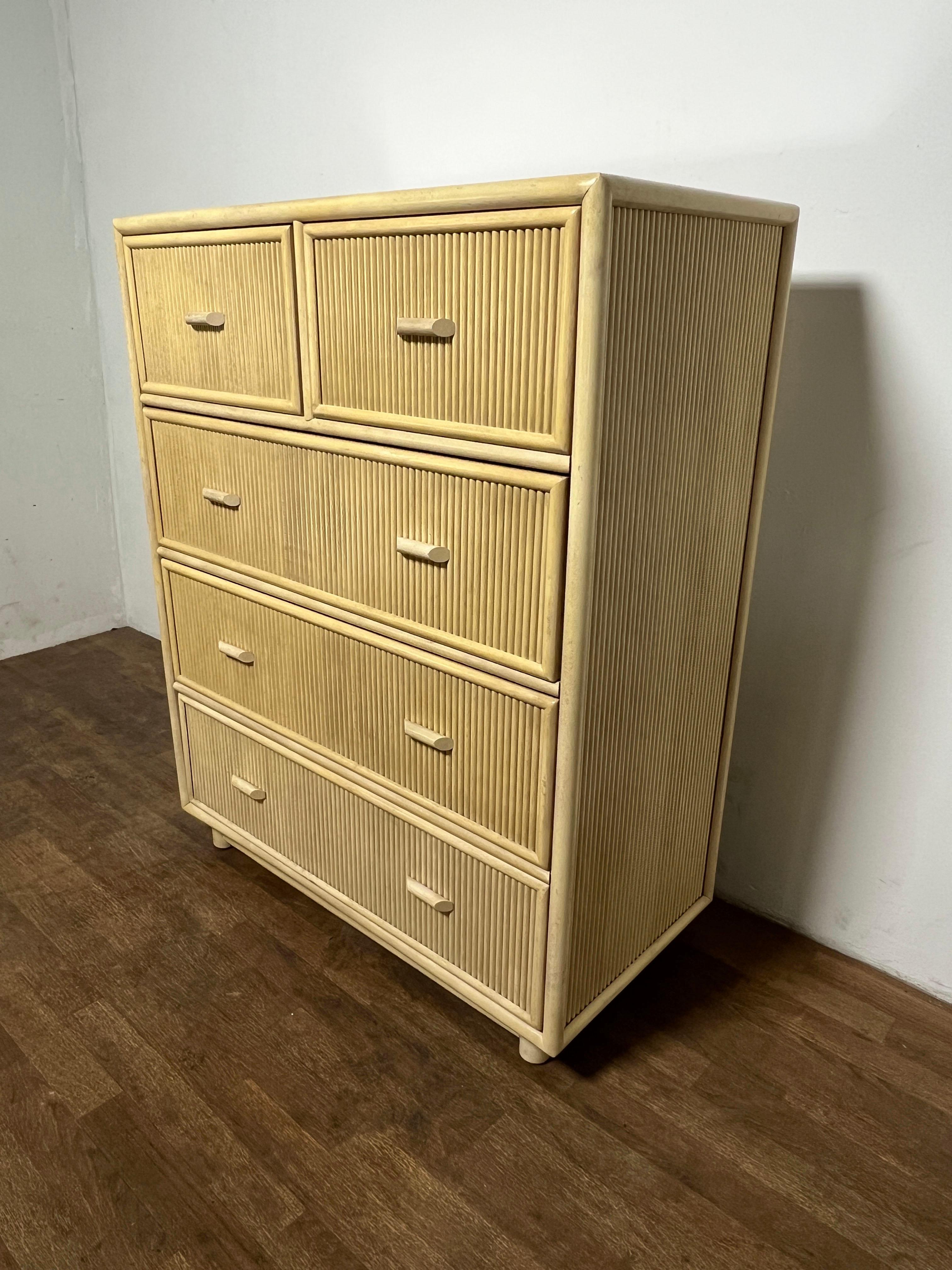 A pencil reed highboy dresser of two drawers over three, circa 1970s, made in Taiwan. Can be used with or without the accompanying glass top insert.

See our separate listing for a matching pair of night stands.