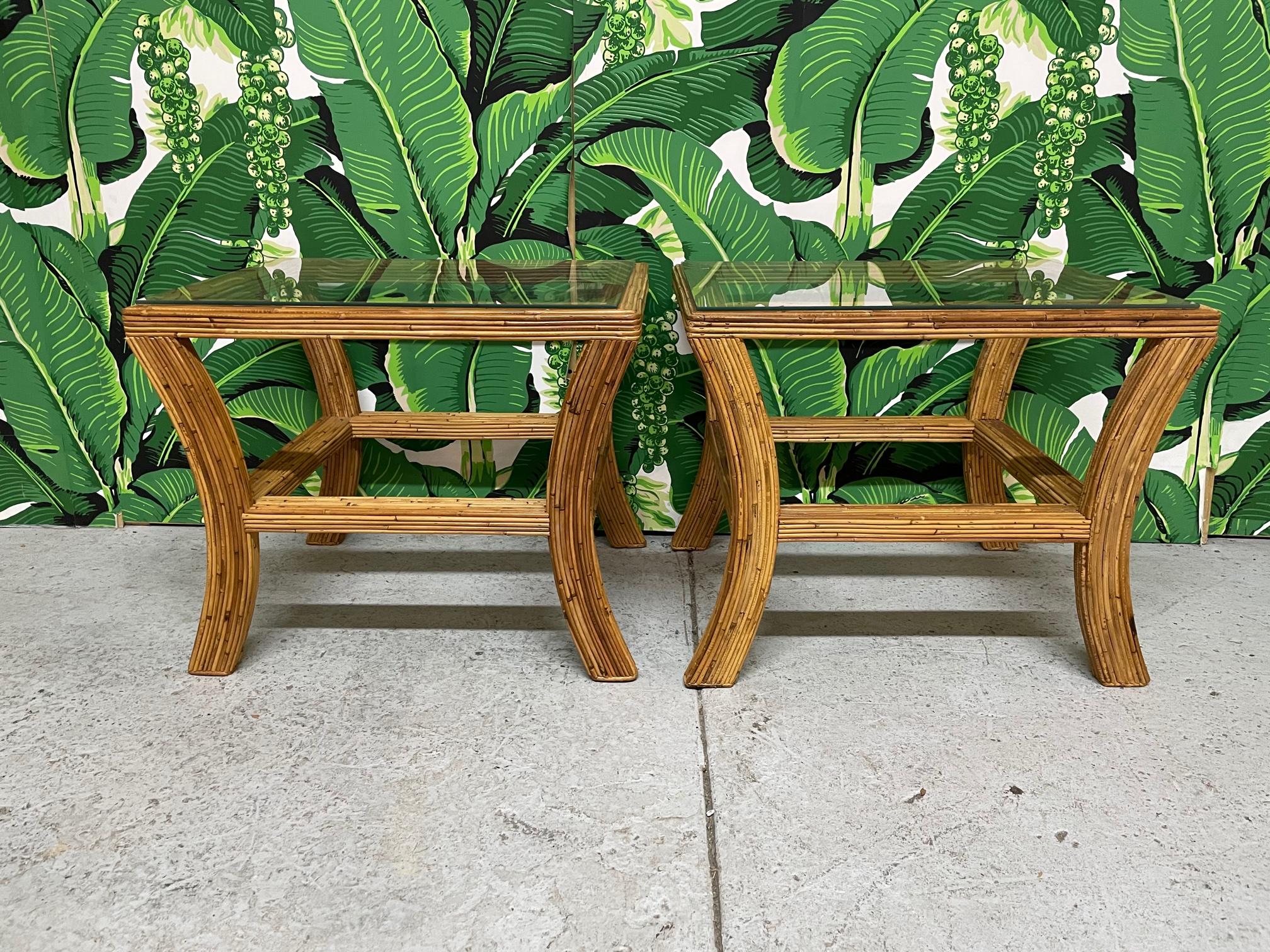 Pair of vintage split reed rattan end tables, could also be nightstands. Splayed leg design with glass tops. Good condition with minor imperfections consistent with age.