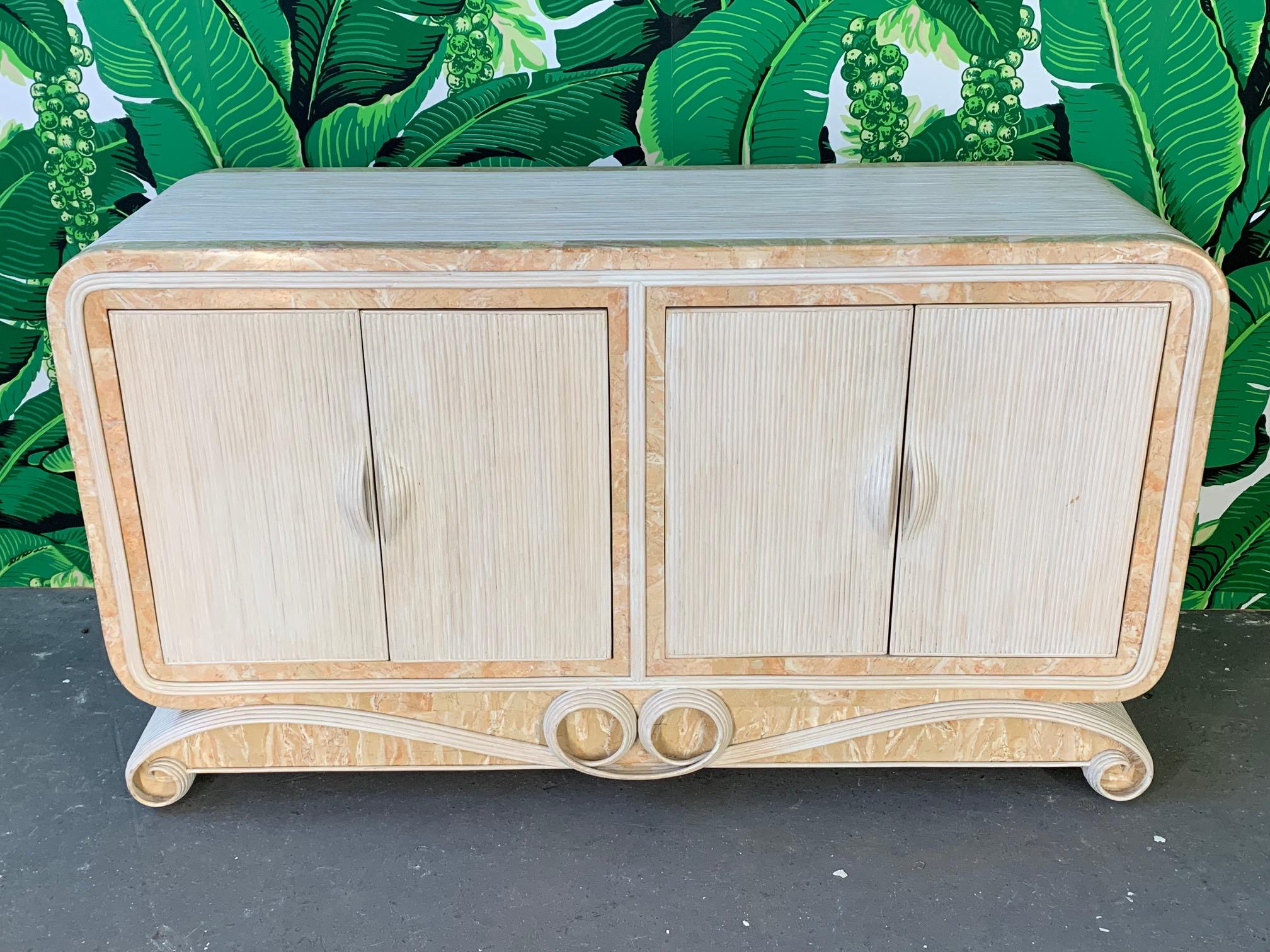 Pencil reed rattan buffet features stone inlay accents and ribbon scroll styling. Four doors reveal shelving for storage. Very good condition with only very minor imperfections consistent with age. One small crack in stone on rear side of top.