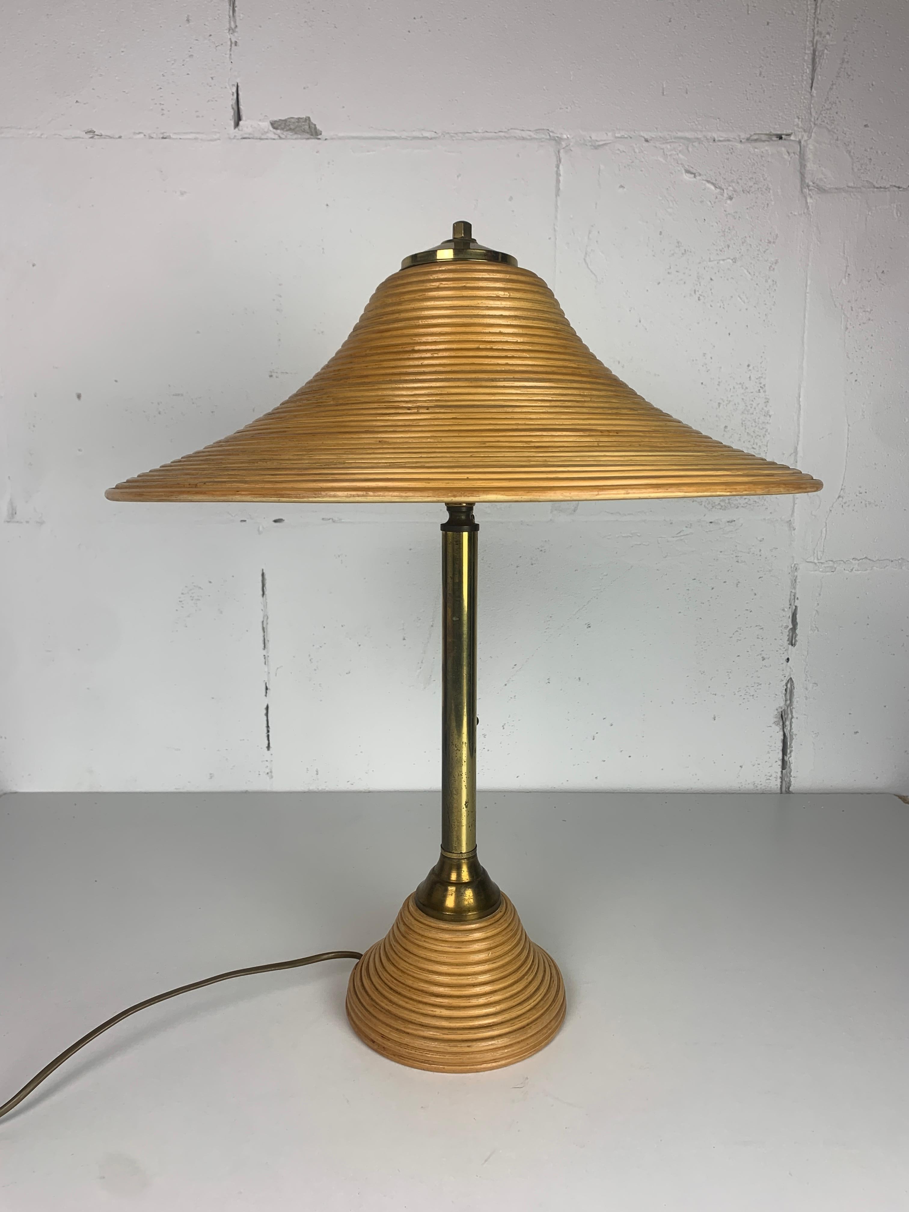 Large ( h 54 cm ) pencil reed rattan and brass table lamp, 1970s often named in the style of Gabriella Crespi. This lamp is in great vintage condition with patinated brass, in great working condition ( original switch cord ) and the lamp is fitted