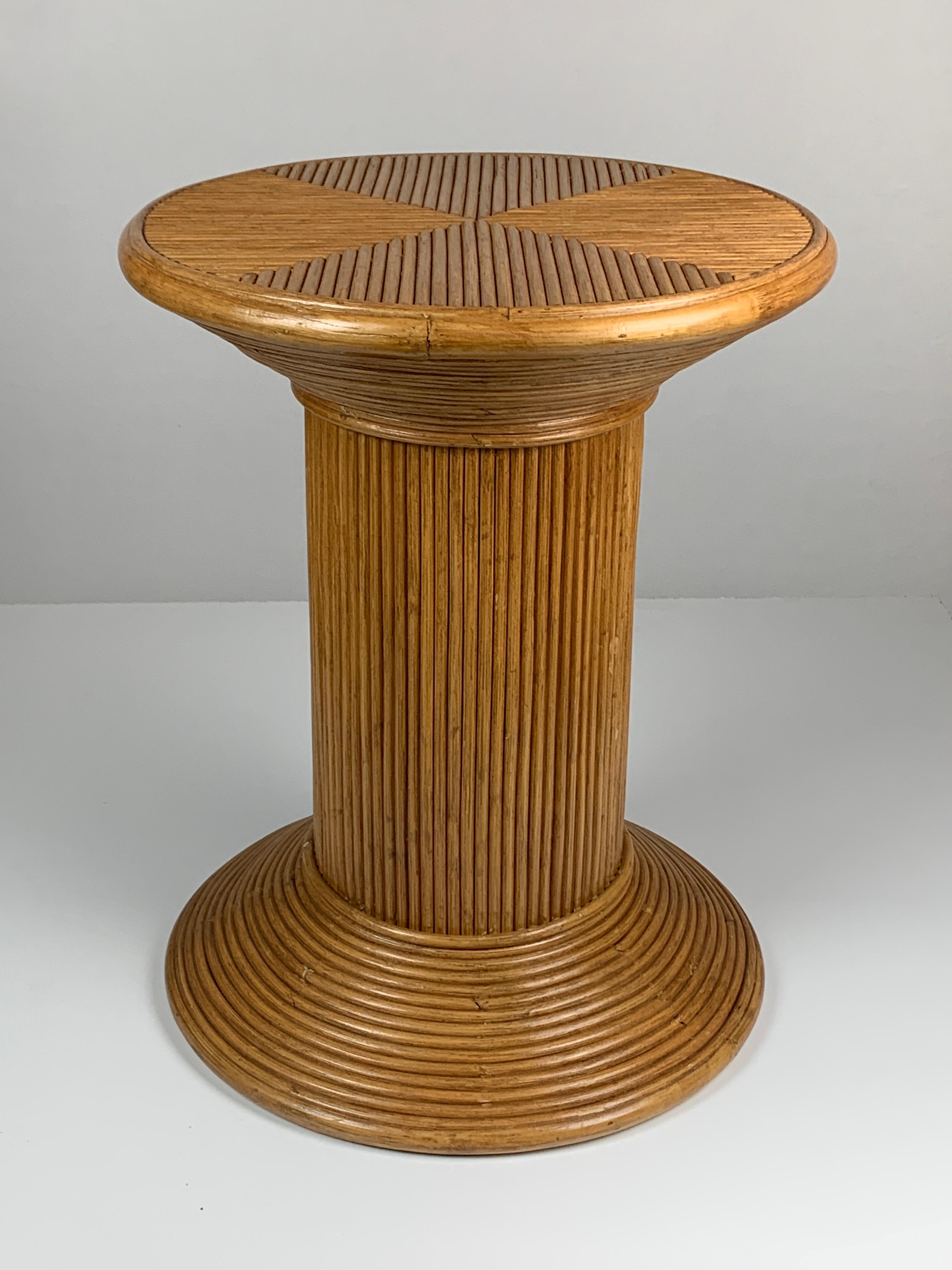 Pencil reed rattan pedestal or side table commonly attributed to italy and often named by or in the style of vivai del sud. Generally made in asia but most likely distributed though italy in the 1970s - 1980s. This side table in in great vintage
