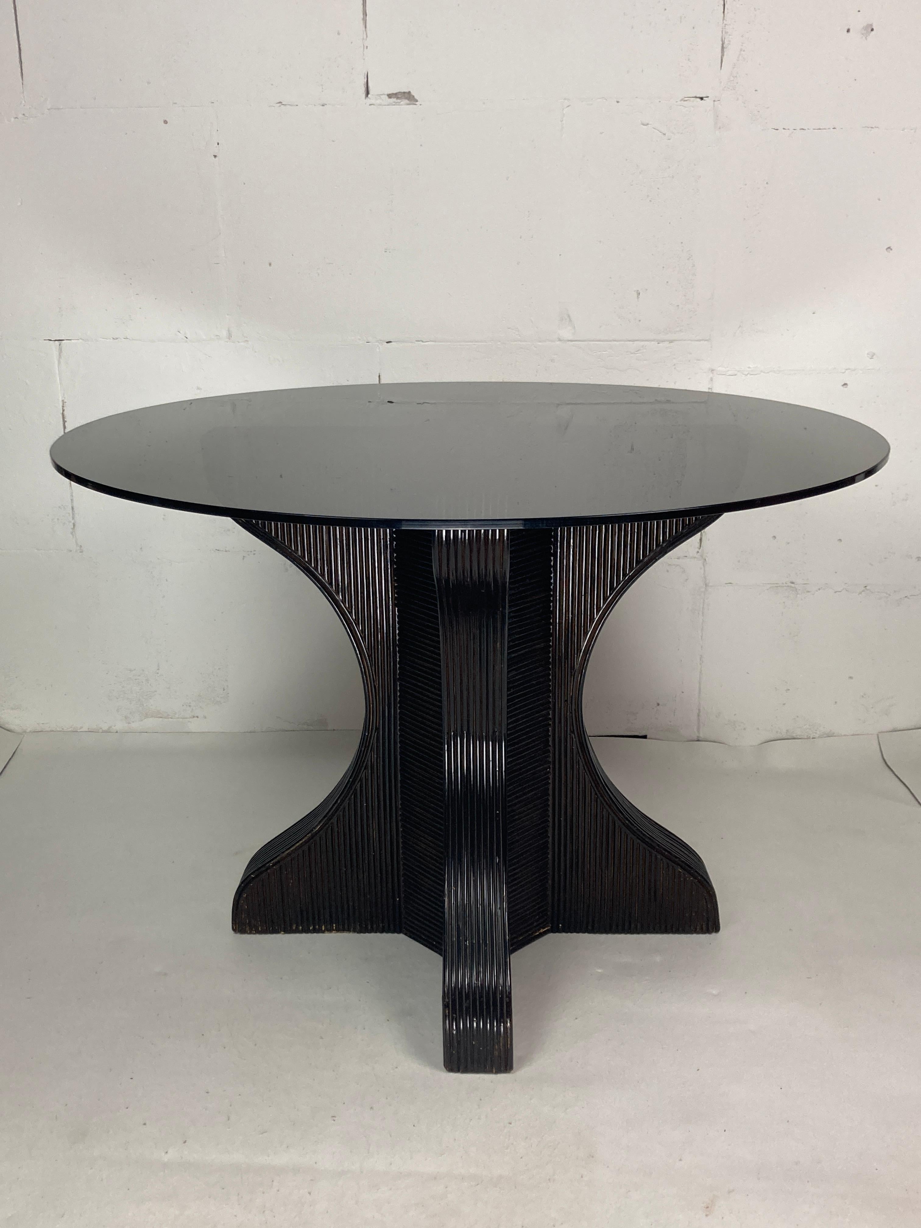 Wonderful deep dark brown pencil or split reed table base with smoked glass top, 1970s. This table base in in lovely vintage condition with general wear but no real flaws to mention. The smoked glass top has some light scratching around the center
