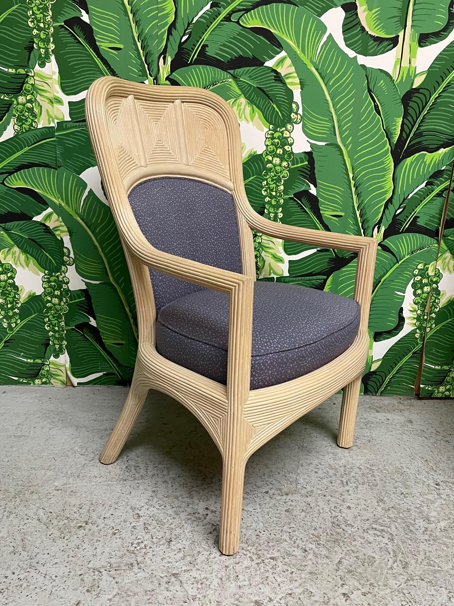 Set of six dining chairs feature full veneer of pencil reed rattan in a unique geometric design. Comfortable back and seat cushions. Upholstered in a purple floral pattern. Very good condition with only minor imperfections consistent with age (see