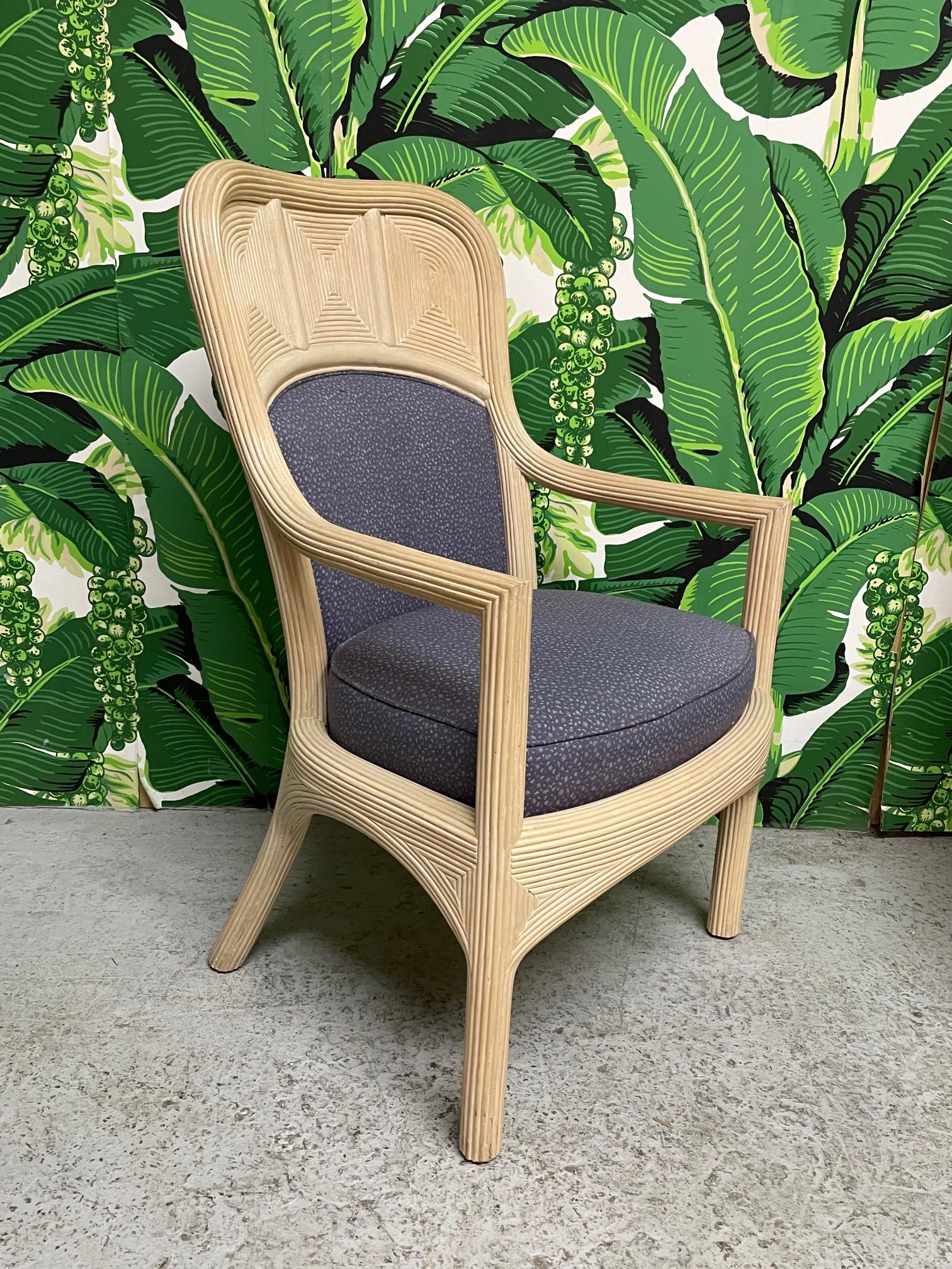 Set of six dining chairs feature full veneer of pencil reed rattan in a unique geometric design. Comfortable back and seat cushions. Upholstered in a purple floral pattern. Very good condition with only minor imperfections consistent with age. May