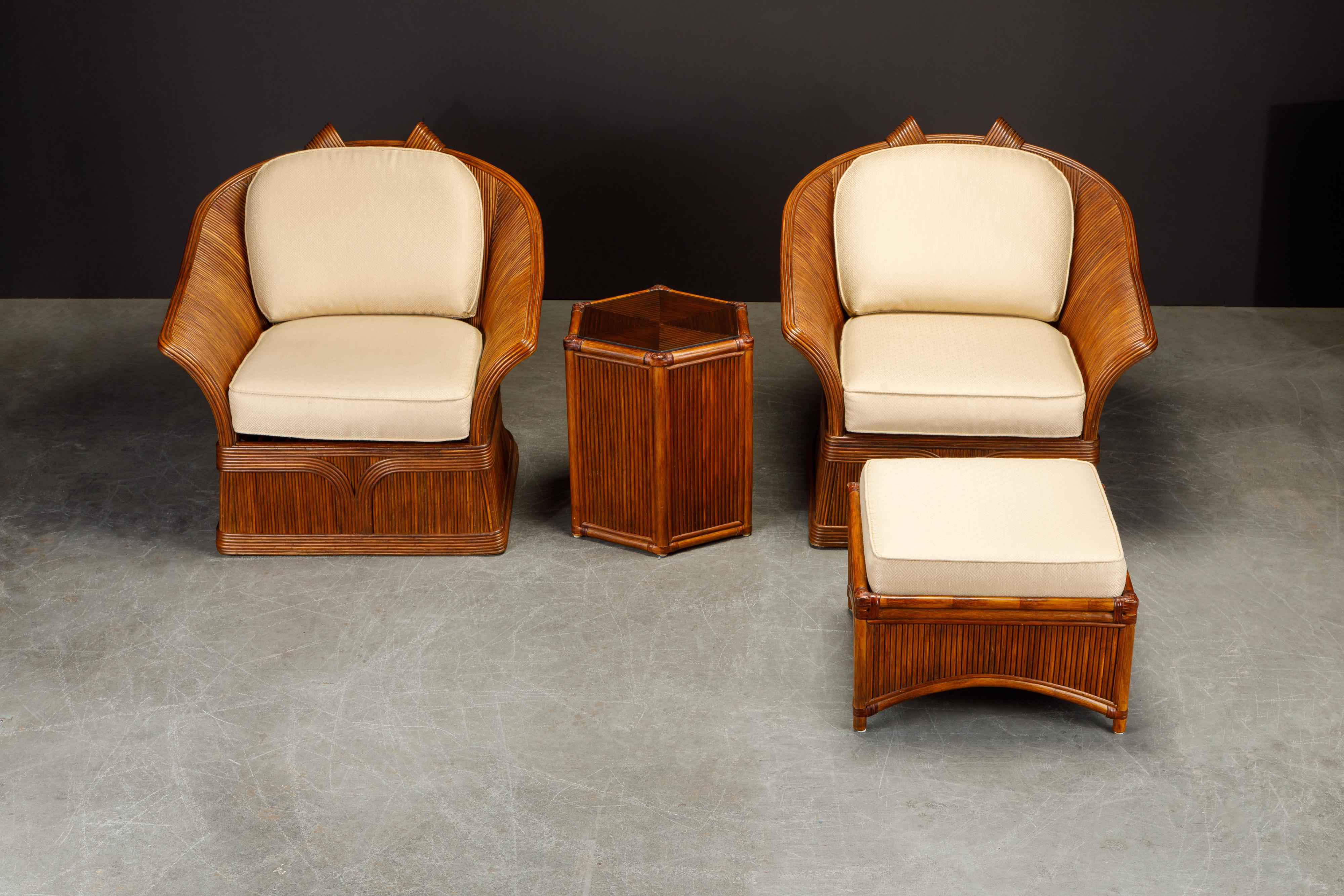 This beautiful set attributed to Betty Cobonpue includes two lounge armchairs, an ottoman and a side table featuring dark brown pencil reed rattan, circa 1980s.  Gorgeous rattan meticulously shaped into trompe l'oeil ribbons grace the sizable and