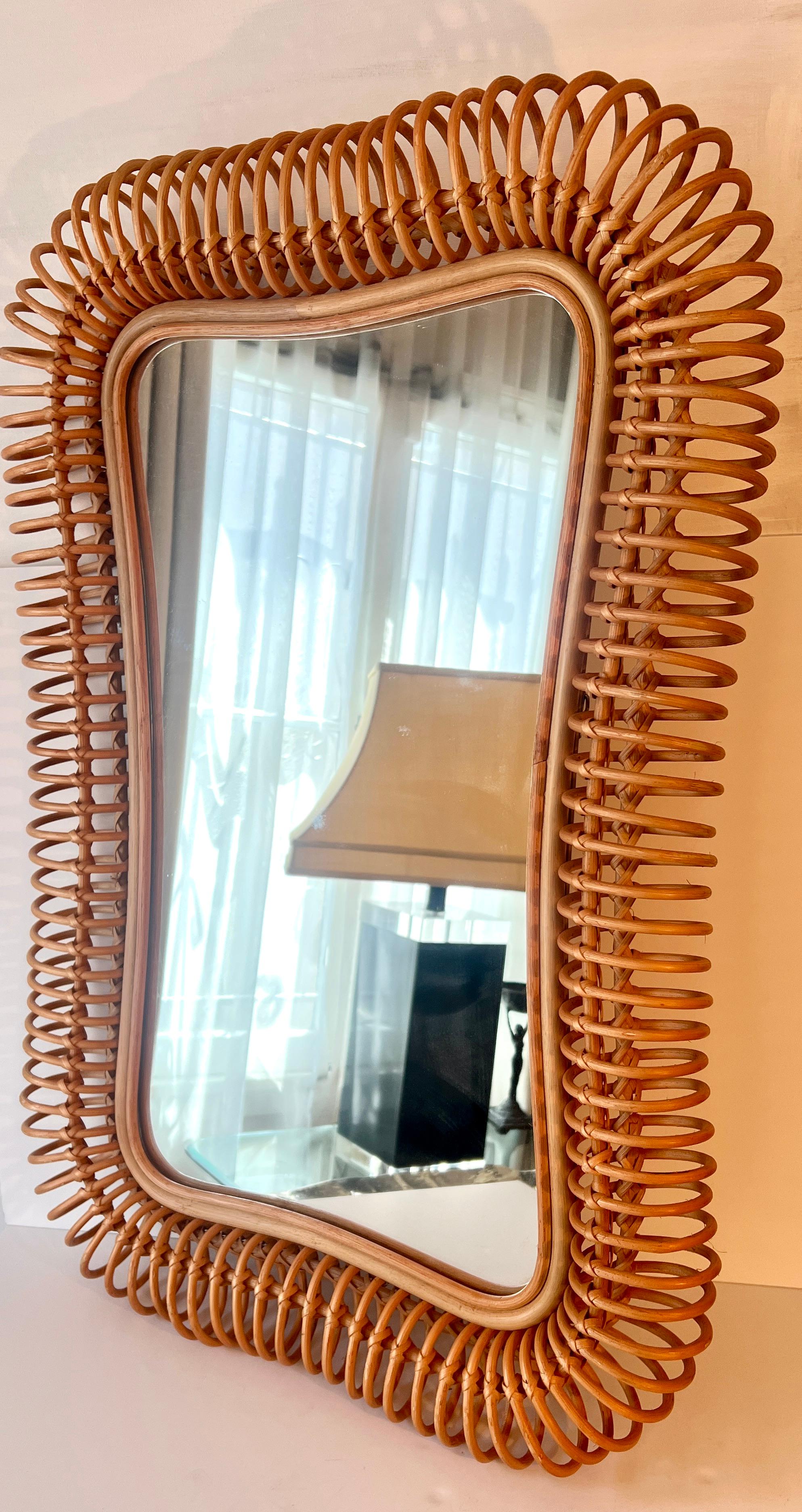 A uniquely fabricated pencil reed wall mirror, while the continuous piece of rattan moves through circular motion, it is woven and tied into place for the next circular motion.

At a glance it looks to be a work of art in its hand crafted beauty.  A