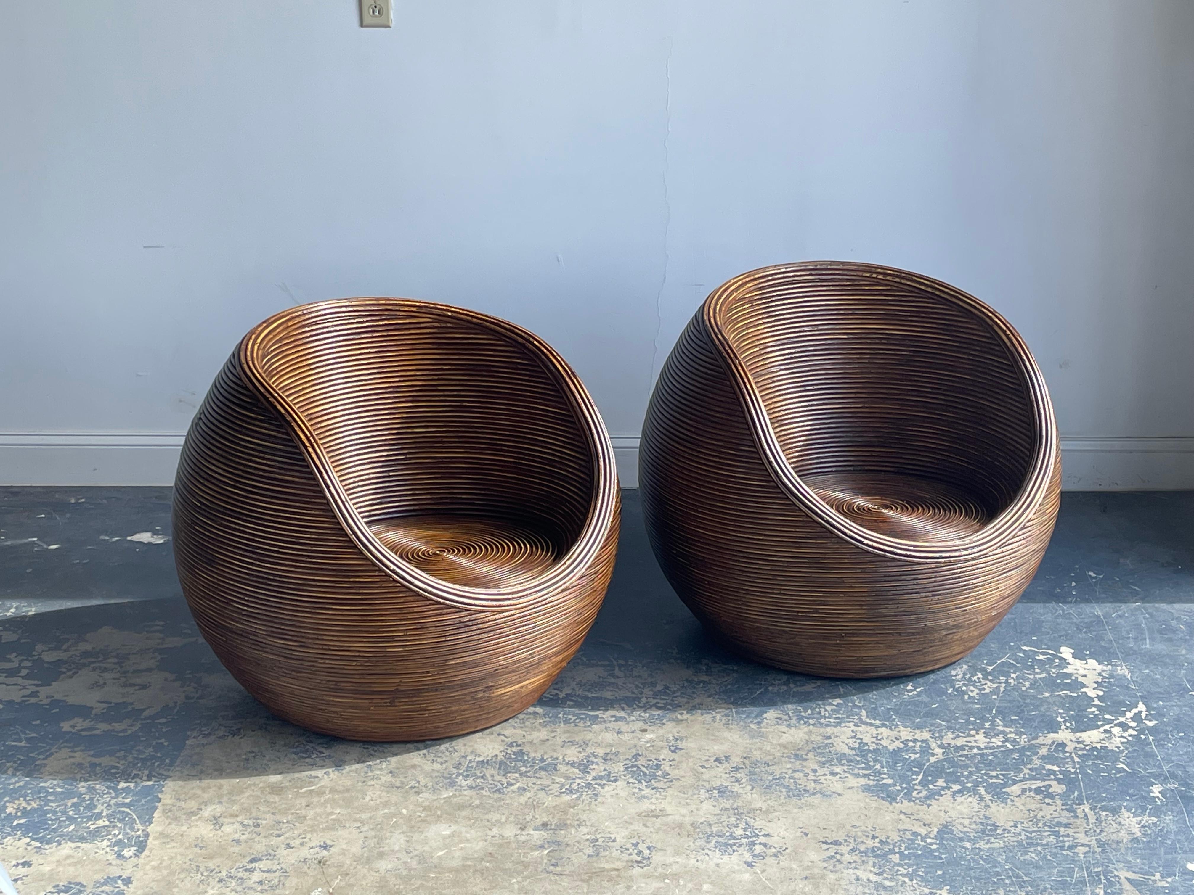 Organic Modernist pair of split reed or pencil reed tub chairs. Wonderful design would blend in a variety settings. Has a very functional sculptural presence. 

Other notable designers from the period include Gabriella Crespi, Adrian Pearsall,