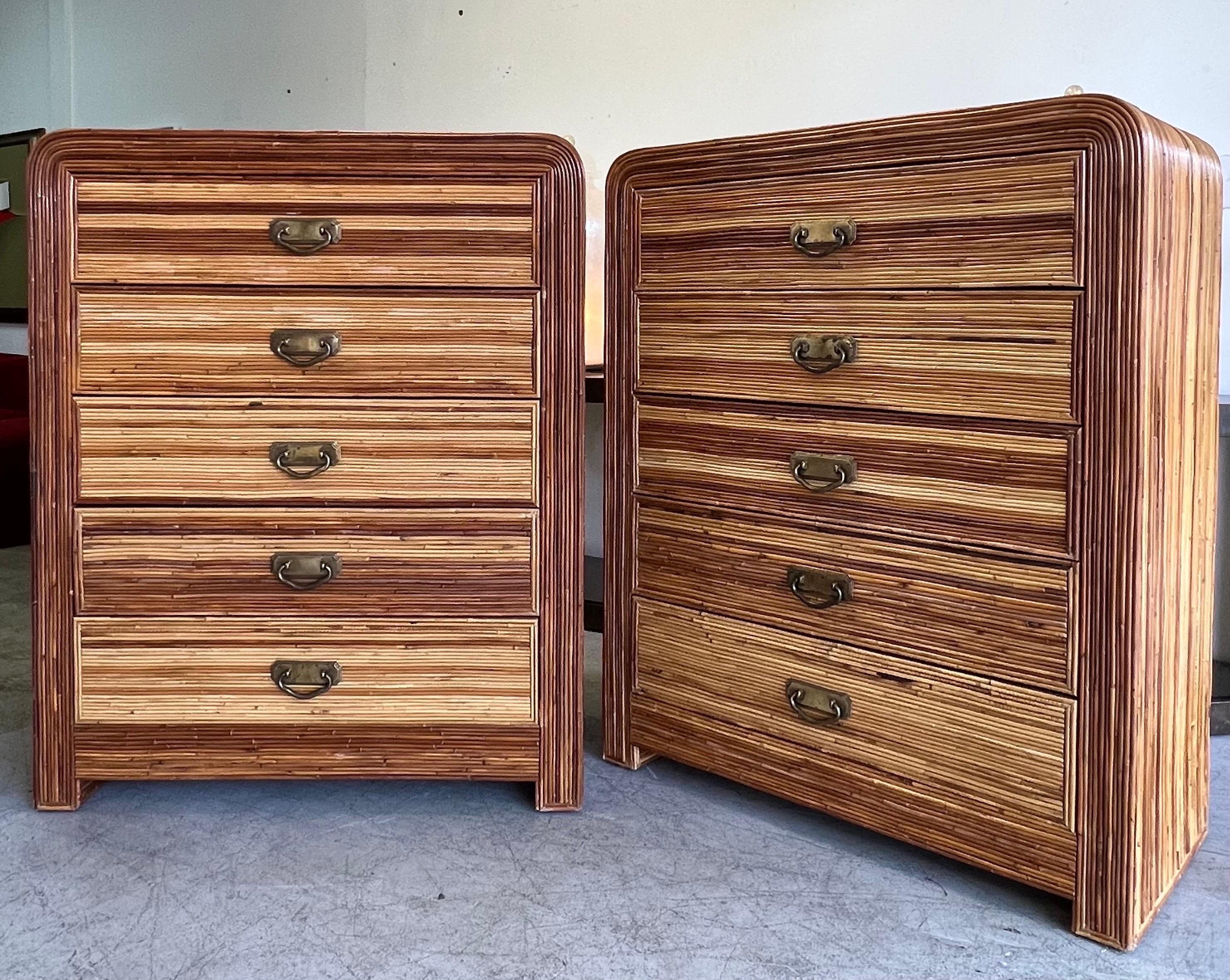 A pair of dressers on pencil reed bamboo. Waterfall design with 5 drawers each. Patinated brass hardware. In very good condition. 