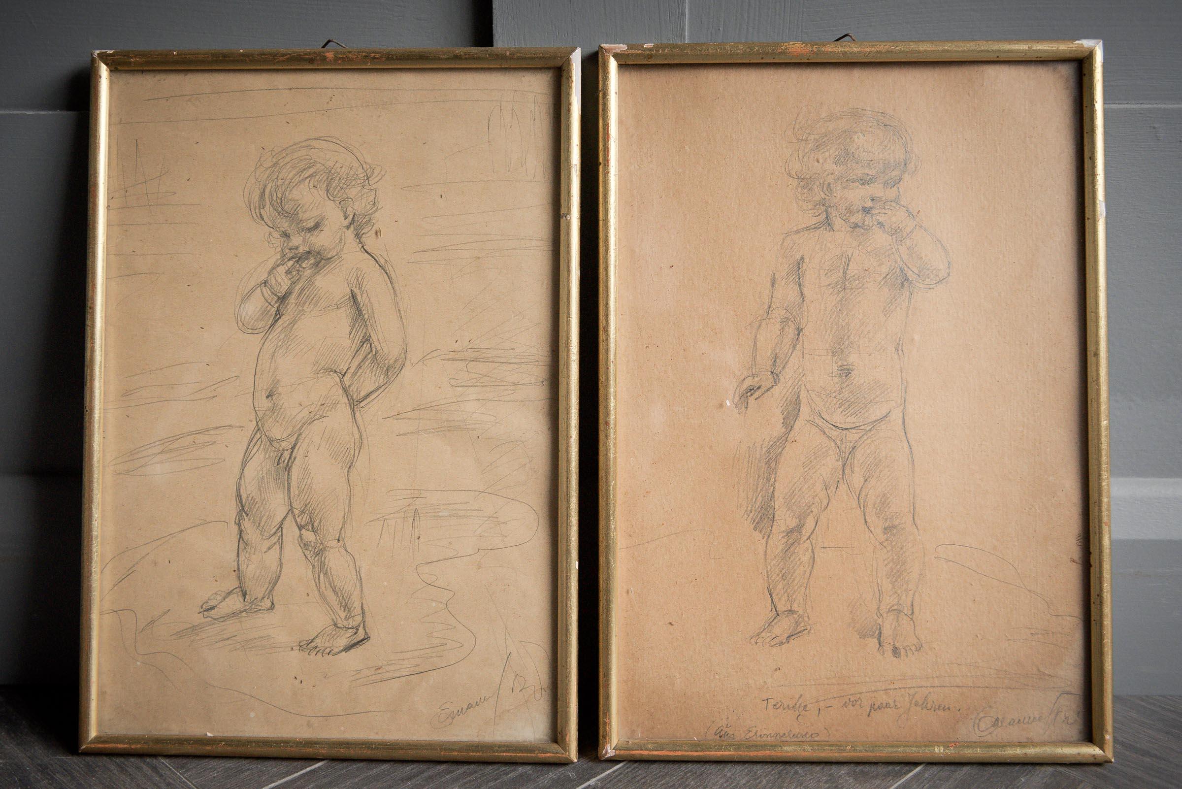 Duo of framed pencil drawings of young boy and girl.