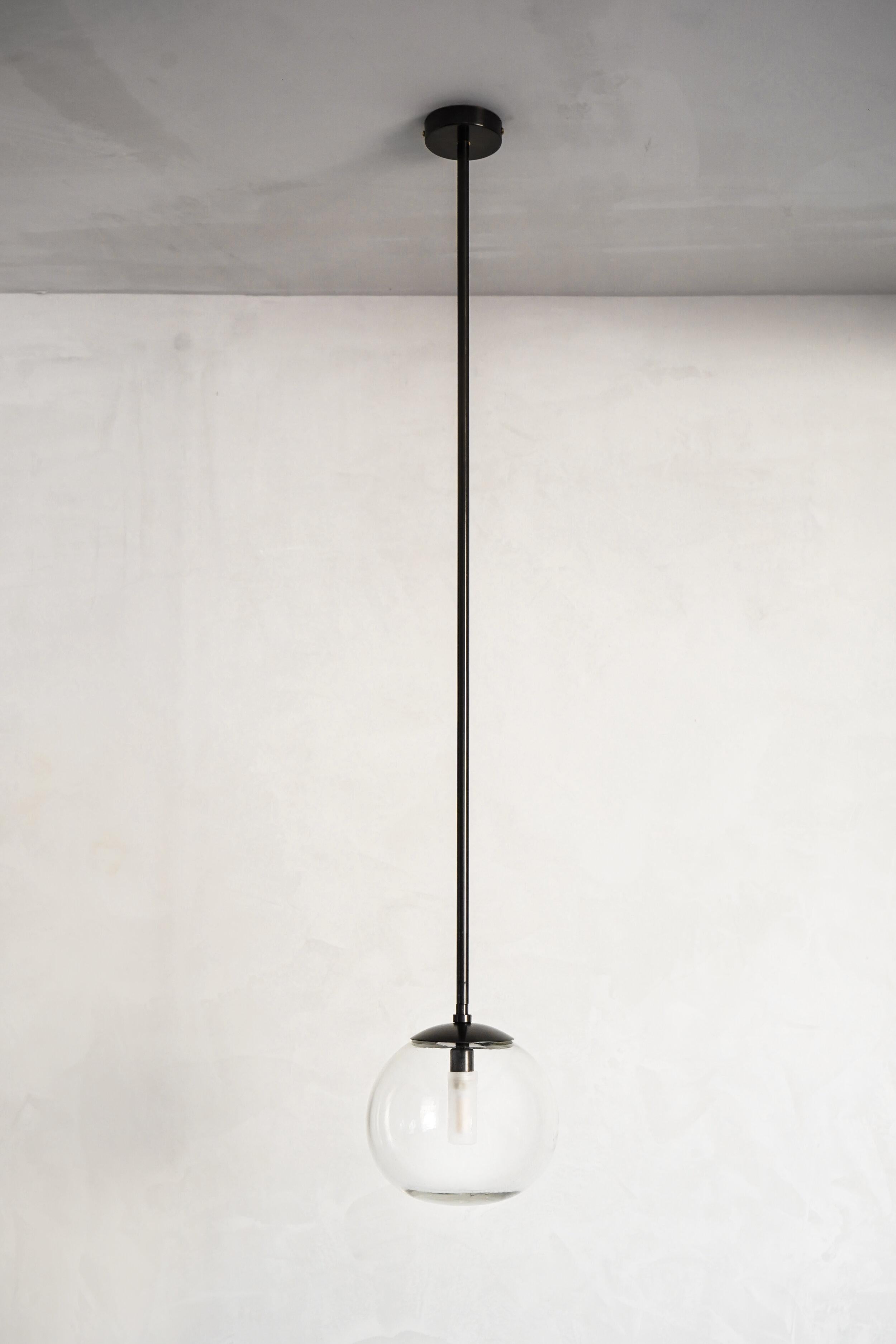 Pendant Ball Tube 18 by Contain
Dimensions: D 18 x H 100cm (custom length).
Materials: Brass tube or cable, 3D printed PLA structure and blown glass from local production.
Available in different finishes and dimensions.

All our lamps can be wired