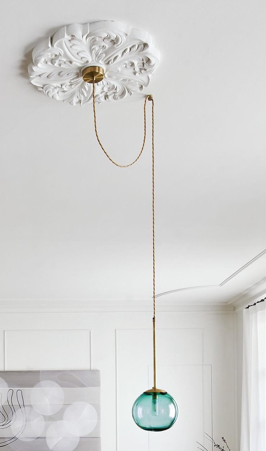 Pendant Ball Cable 18 by Contain
Dimensions: Ø 18 x H 100 cm (custom length).
Materials: Brass cable, 3D printed PLA structure and blown glass from local production.

Available in different finishes and dimensions. Please contact us. 

All our