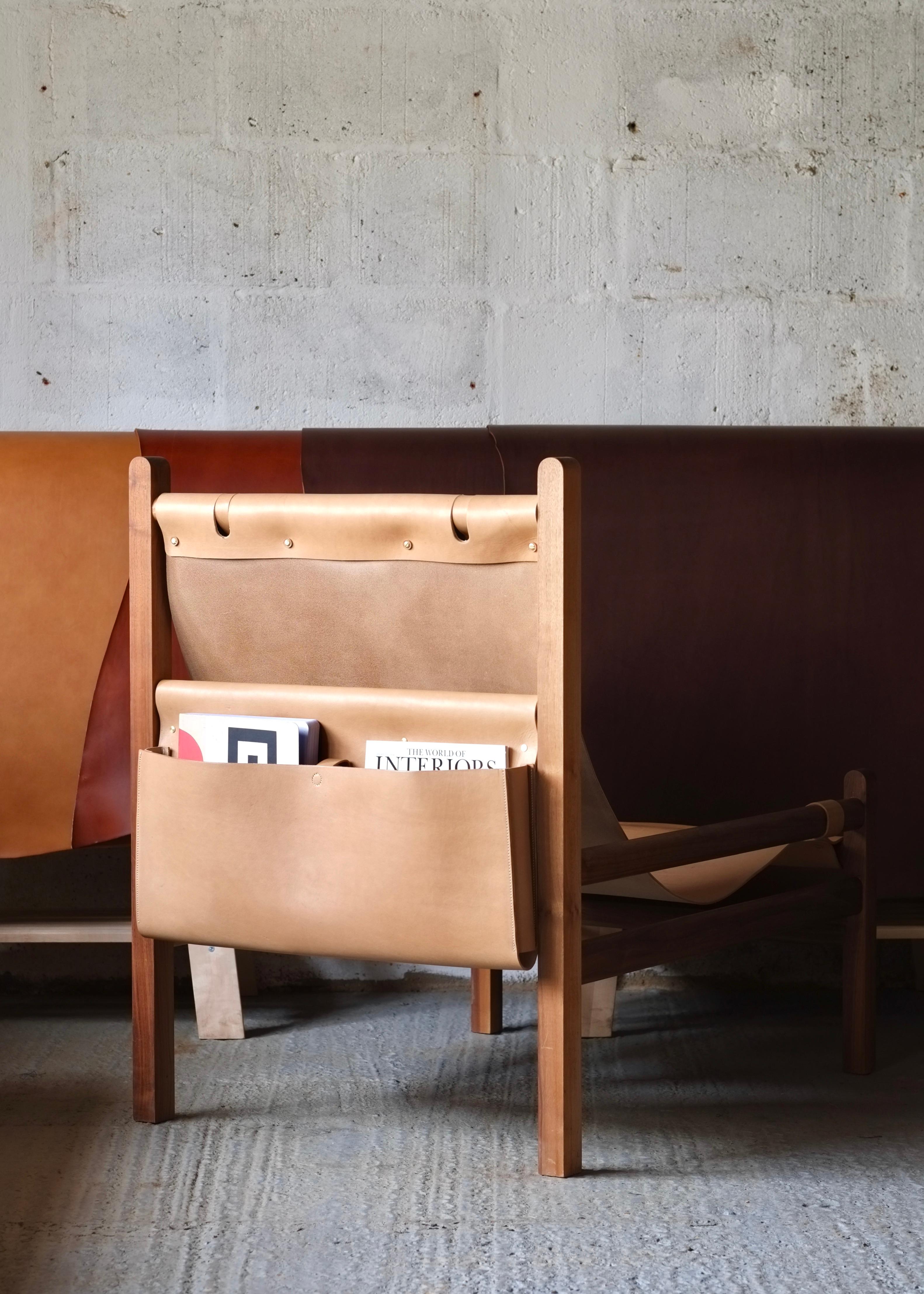 leather and wood sling chair