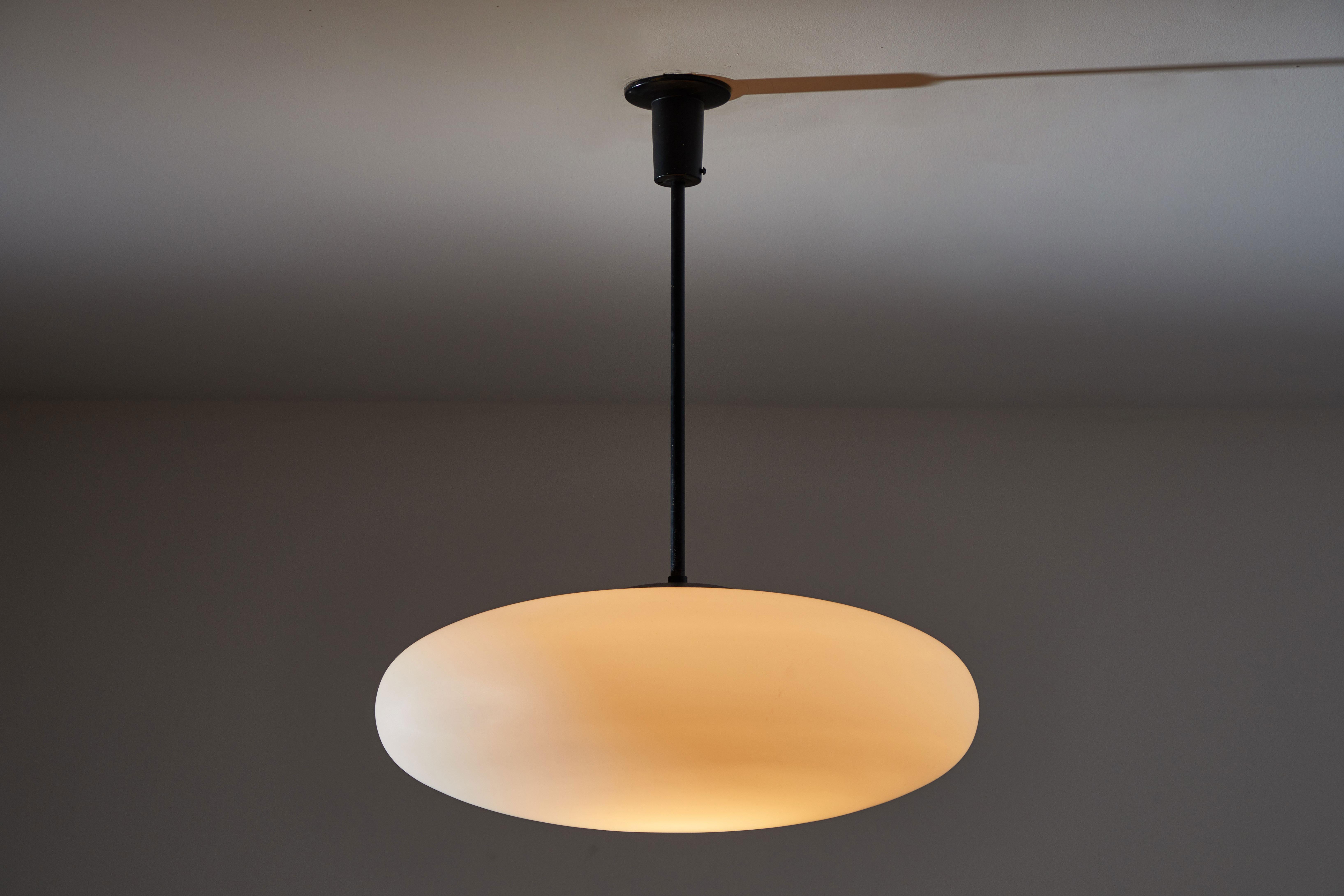 Pendant by Arredoluce. Manufactured in Italy, circa 1950s. Brushed satin glass diffuser, blackened steel hardware. Rewired for US junction boxes. Custom canopy. Takes one E27 100w maximum bulb.