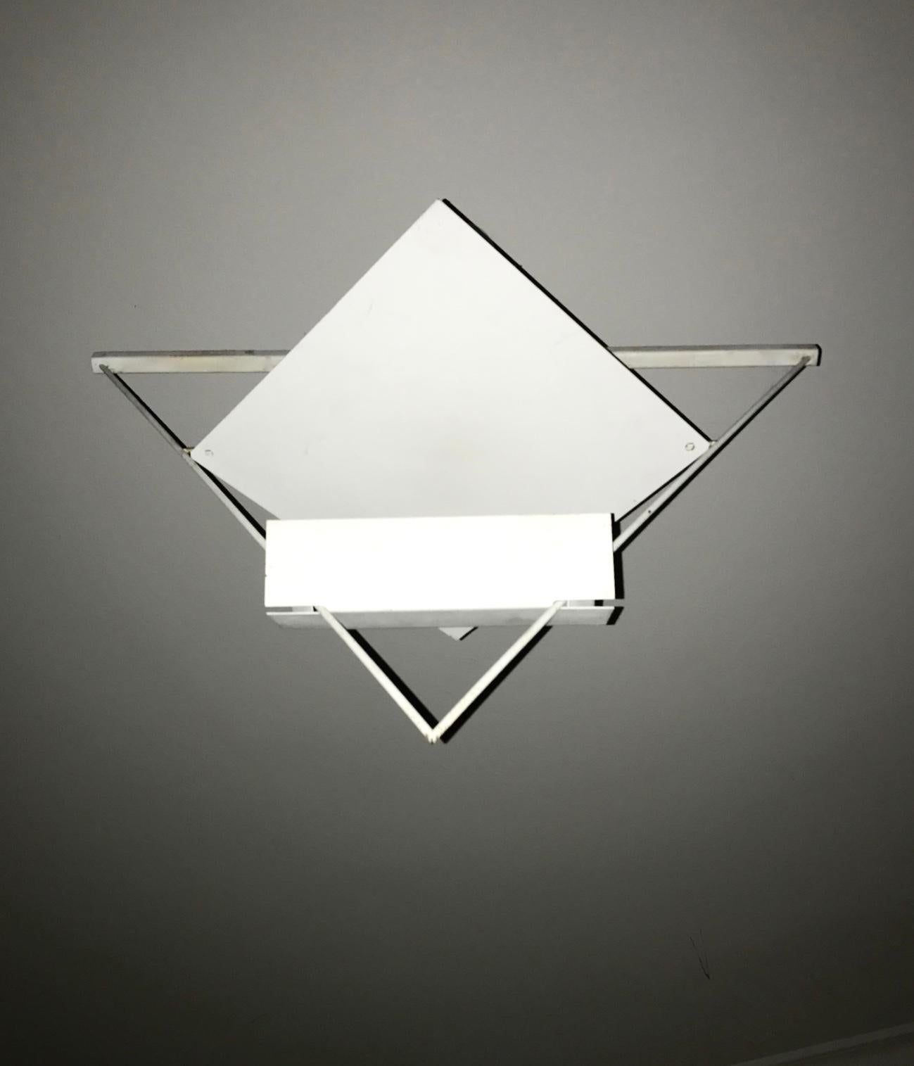 Two pendant by Mario Botta for Artemide
One in white the other in black
Triangular pendant by Mario Botta for Artemide. Designed and manufactured in Italy, circa 1980s. Enameled metal triangular shaped structure which houses a singular halogen