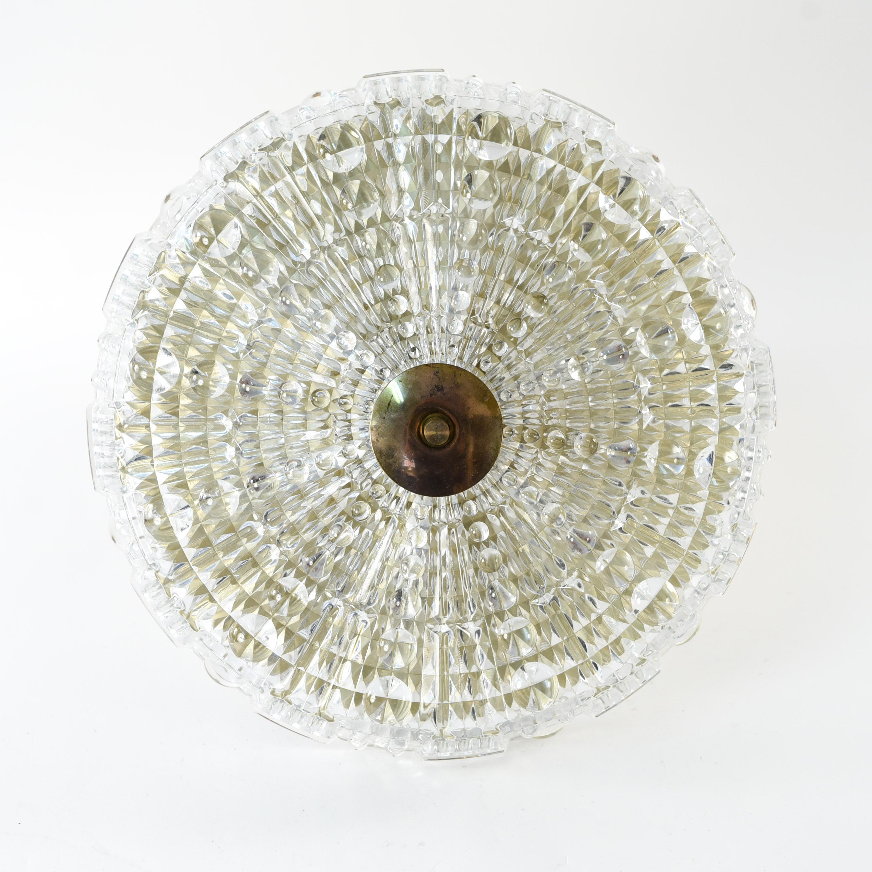 This Swedish crystal pendant chandelier was designed by Carl Fagerlund and produced by Orrefors, circa 1960s. This piece features patterned crystal which provides an interesting design element of texture.