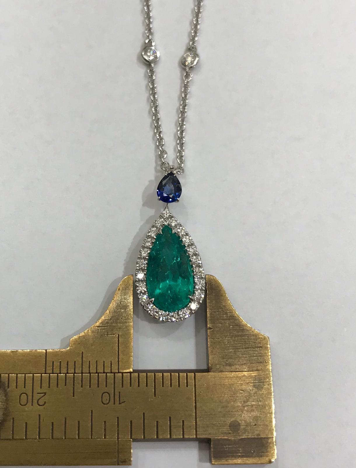 Contemporary Pendant Drop Emerald Necklace in a Circle of Diamonds and Blue Sapphire Drop For Sale