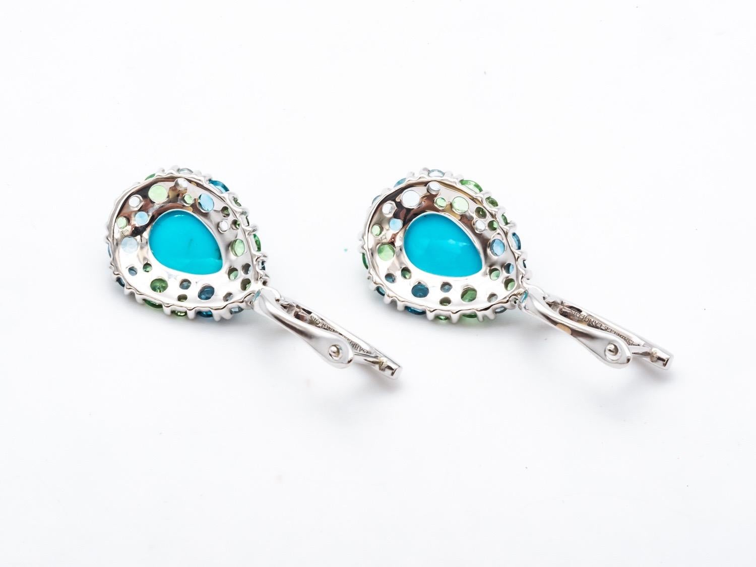 Discover these elegant dangling earrings that embody timeless beauty. Crafted with topaz, tsavorite, turquoise and diamonds in white gold, these exquisite earrings are designed to catch the light and draw attention with their mesmerizing sparkle.