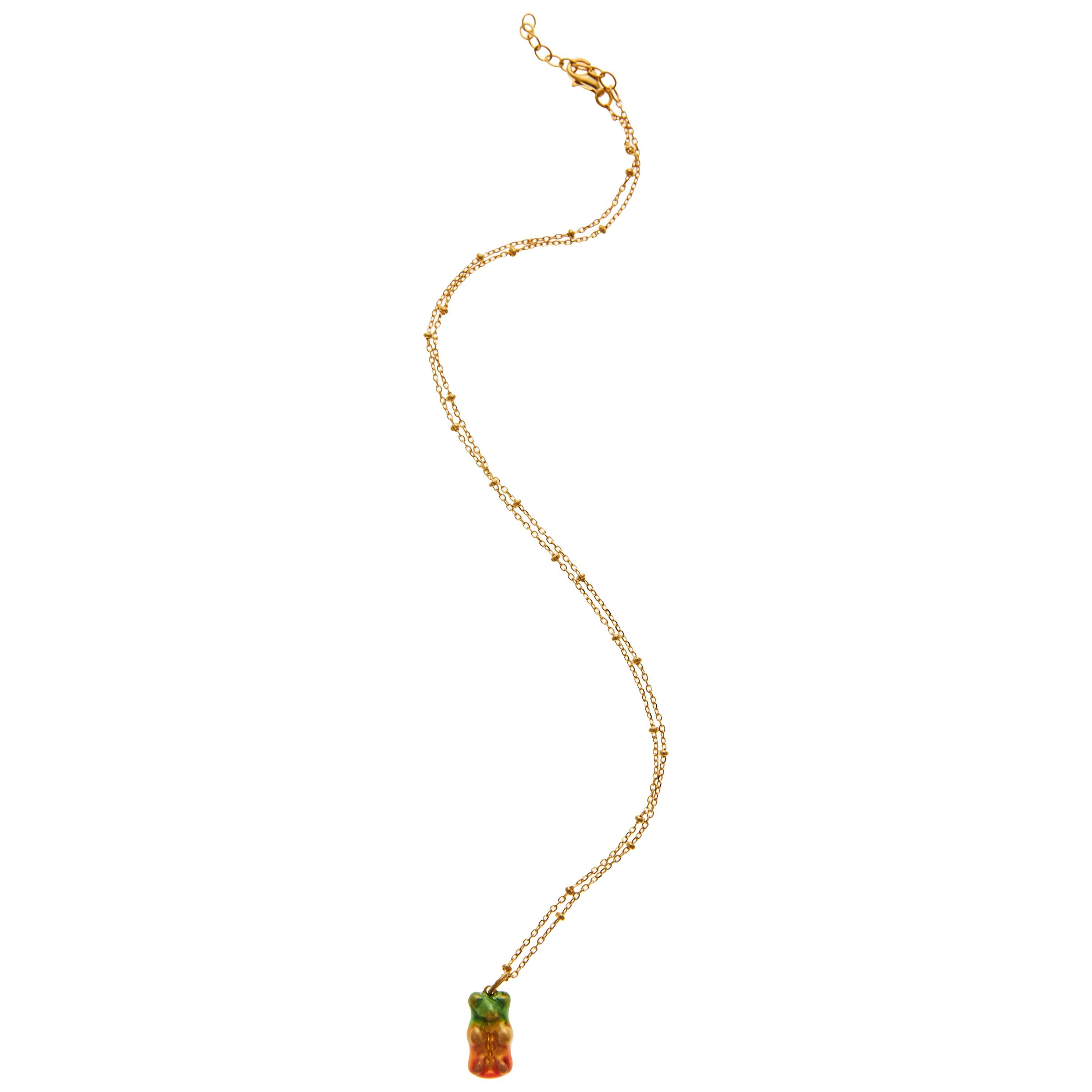 18k gold plated silver  gummy bear pendant for kids  on silver gold plated  chain with transparent green yellow and pink enamel coverage. 

The Gummy Project by Maggoosh is a capsule collection inspired by the designer's life in New York City and