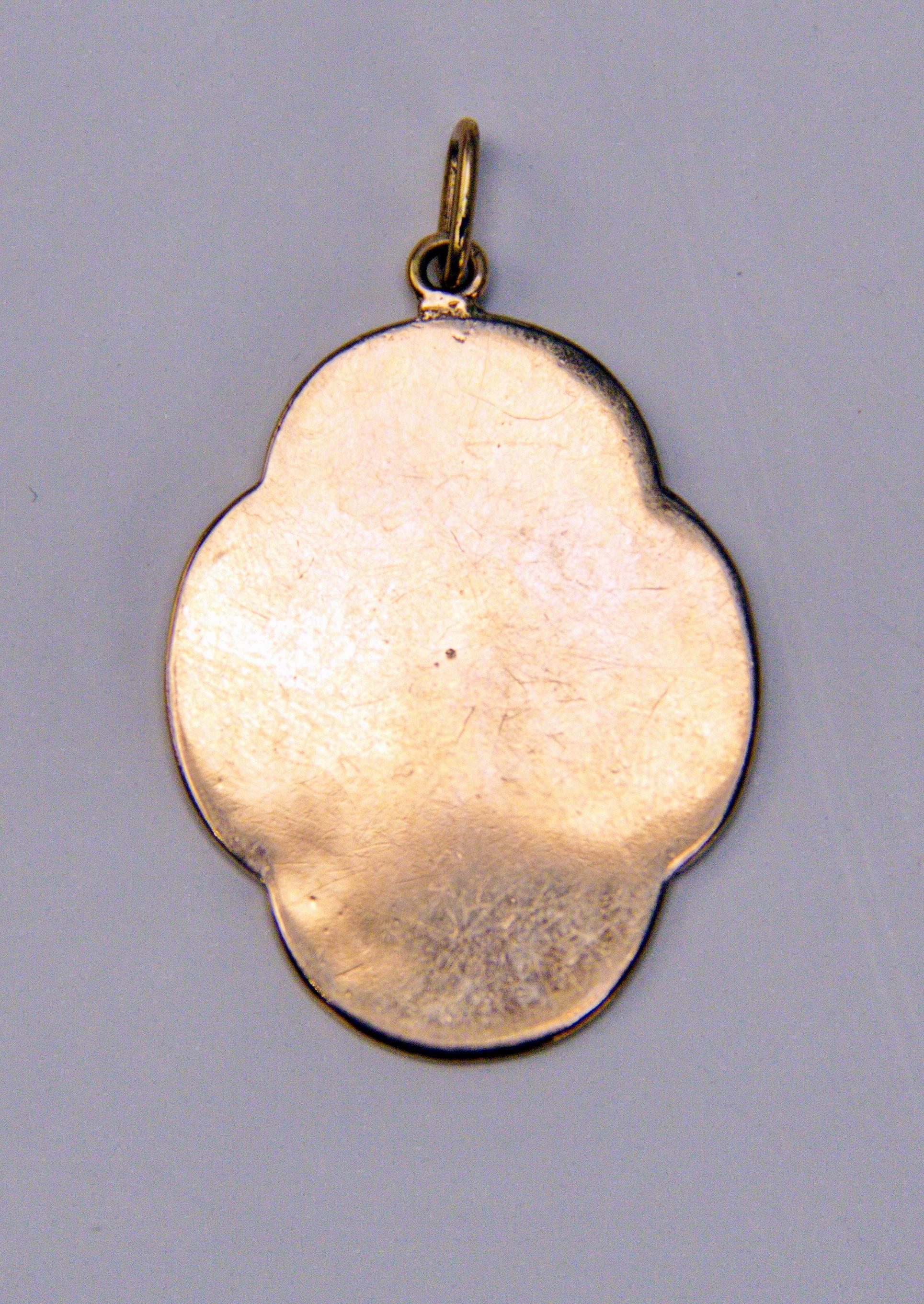 Golden Pendant of lovely appearance, manufactured as following:
Pendant made of porcelain is of oval form type / its edges are waved. The pendant's front side is painted (= enamel painting)  with picture of VIRGIN MARY - clad in white dress and blue