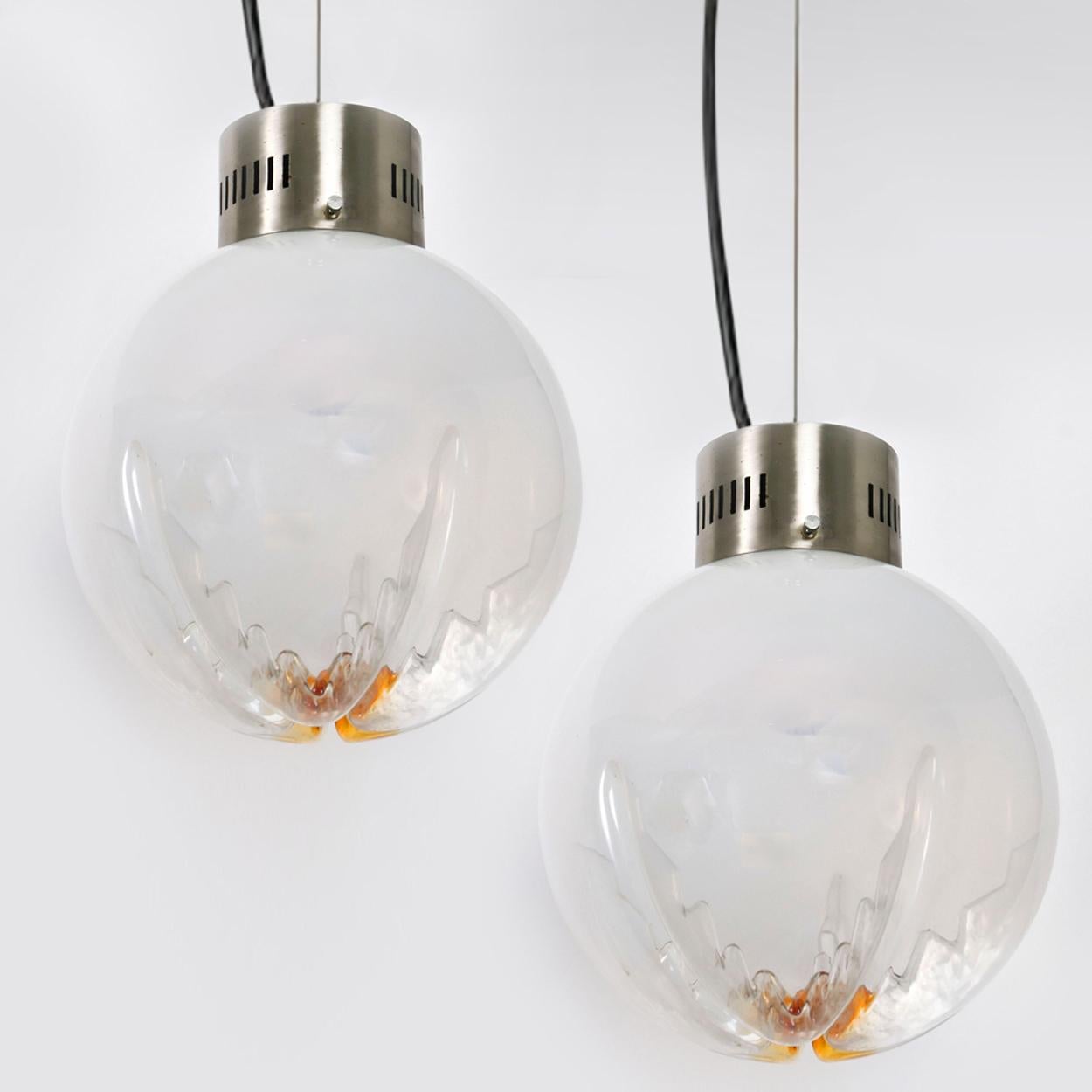 Una lampada a sospensione organica a globo singolo prodotta da Mazzega, Italia. Disegnato da Carlo Nason. Il globo floreale in vetro opaco e vetro arancione è appeso a un cavo d'acciaio e a un cavo nero regolabile in altezza. La lampadina E27 a vite