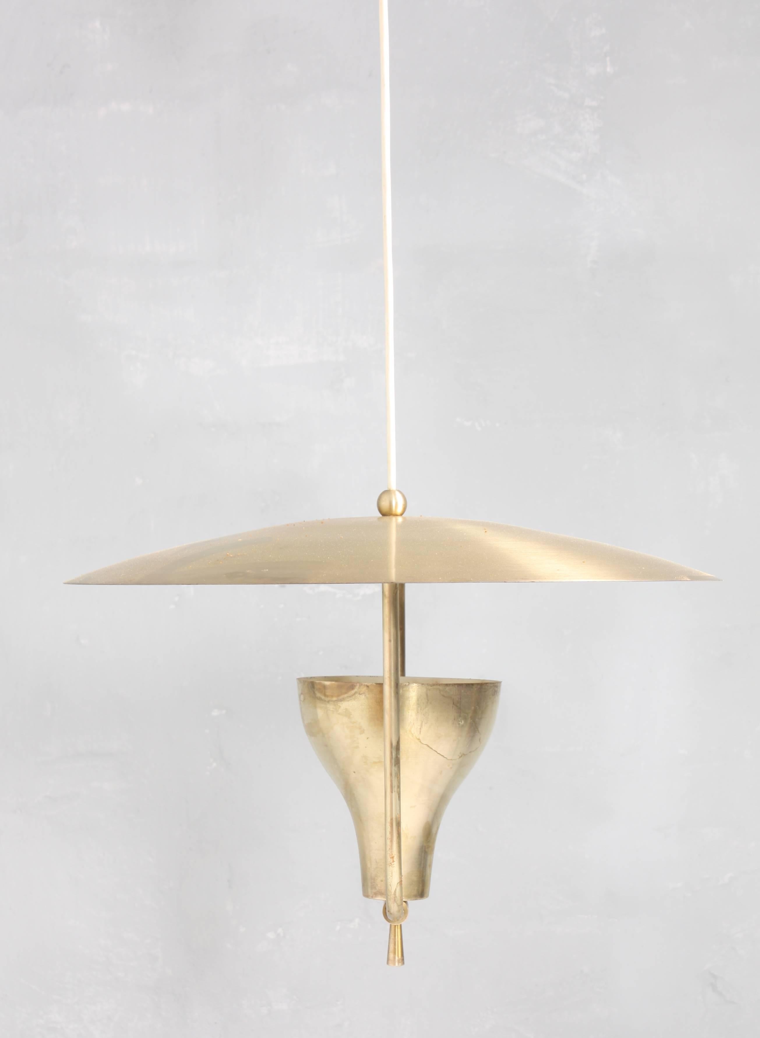 This adjustable pendant in patinated brass is designed and made by Holm Sørensen, Denmark, circa 1958. Great original condition.