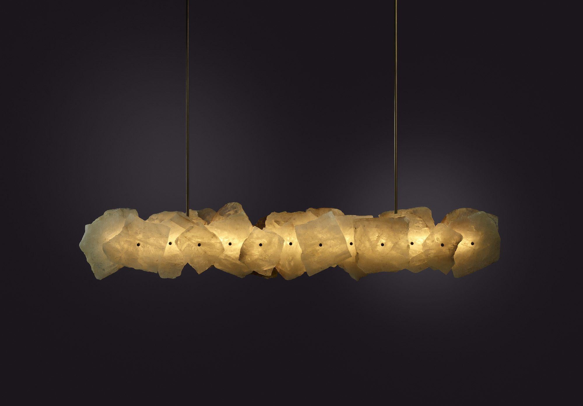 `Contemporary Pendant in Quartz Slices and Brass - Petra II Linear 900 by Christopher Boots

PETRA (from the Greek, meaning stone) celebrates the subtleties and complexities of quartz. Quartz was highly revered by the ancients who believed that it