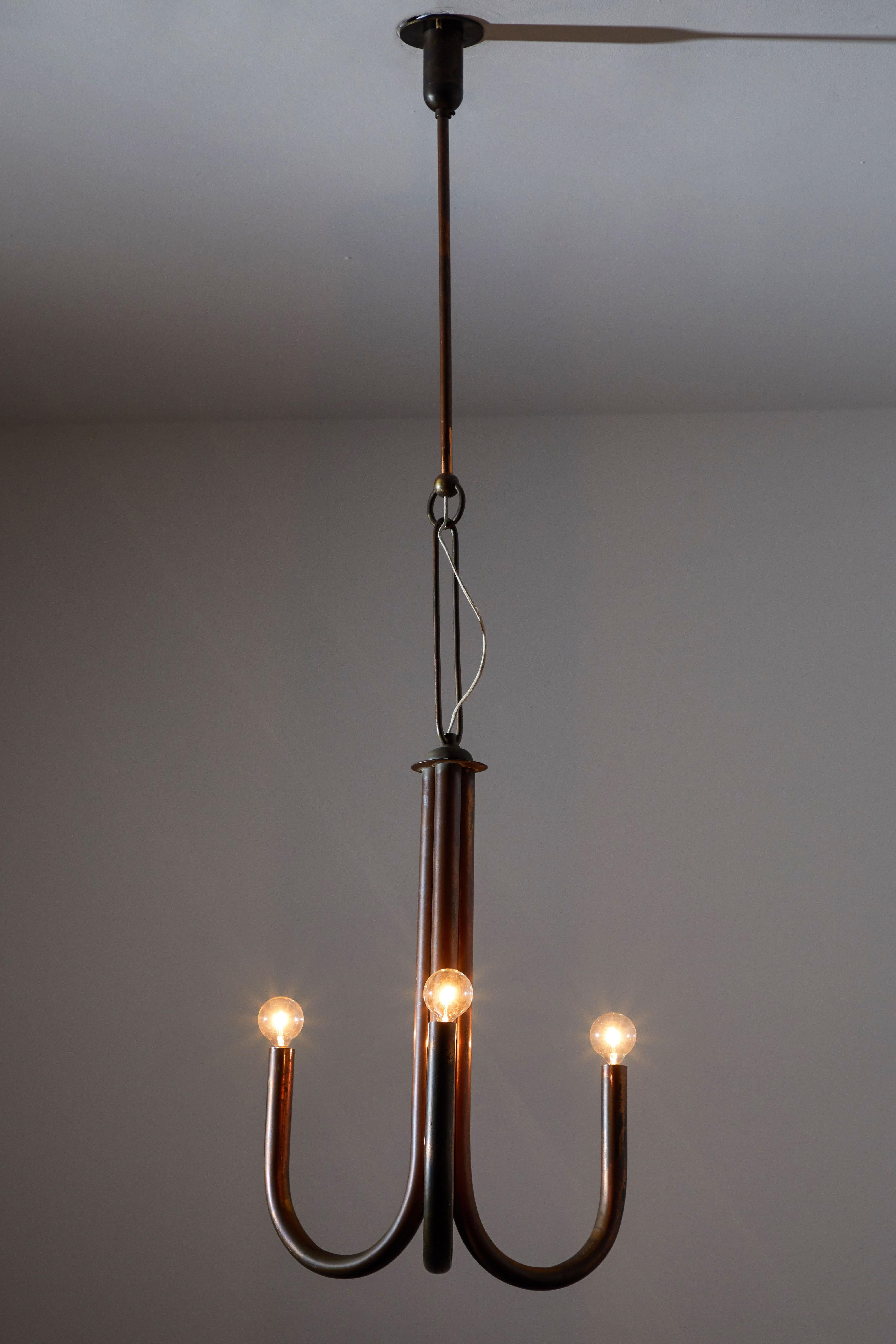 Pendant attributed to Guglielmo Ulrich. Manufactured in Italy circa late 1930s. Copper plated brass with custom brass ceiling plate. Rewired for US junction boxes. Takes three E27 candelabra bulbs, 40 watts maximum each. Bulbs provided as a one time