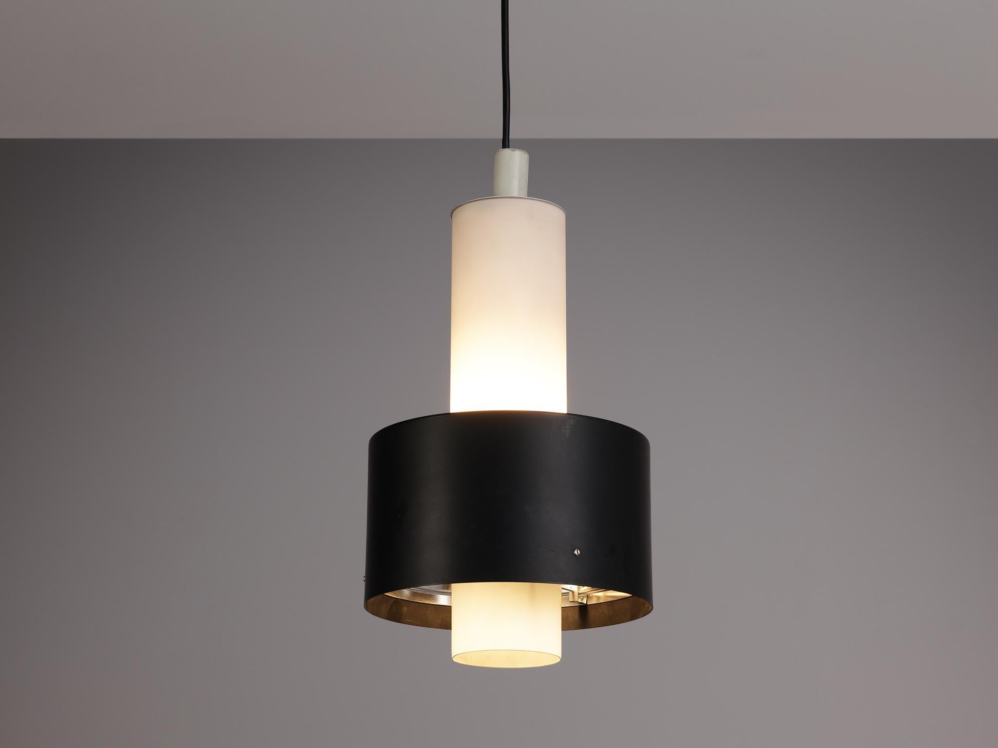 Pendant, metal, Europe, 1970s. 

A circular pendant with consisting of two parts in black and white lacquered metal. A fresh design in neutral colors. The shade is quite large, making it a remarkable light source in a space or room.

Please note