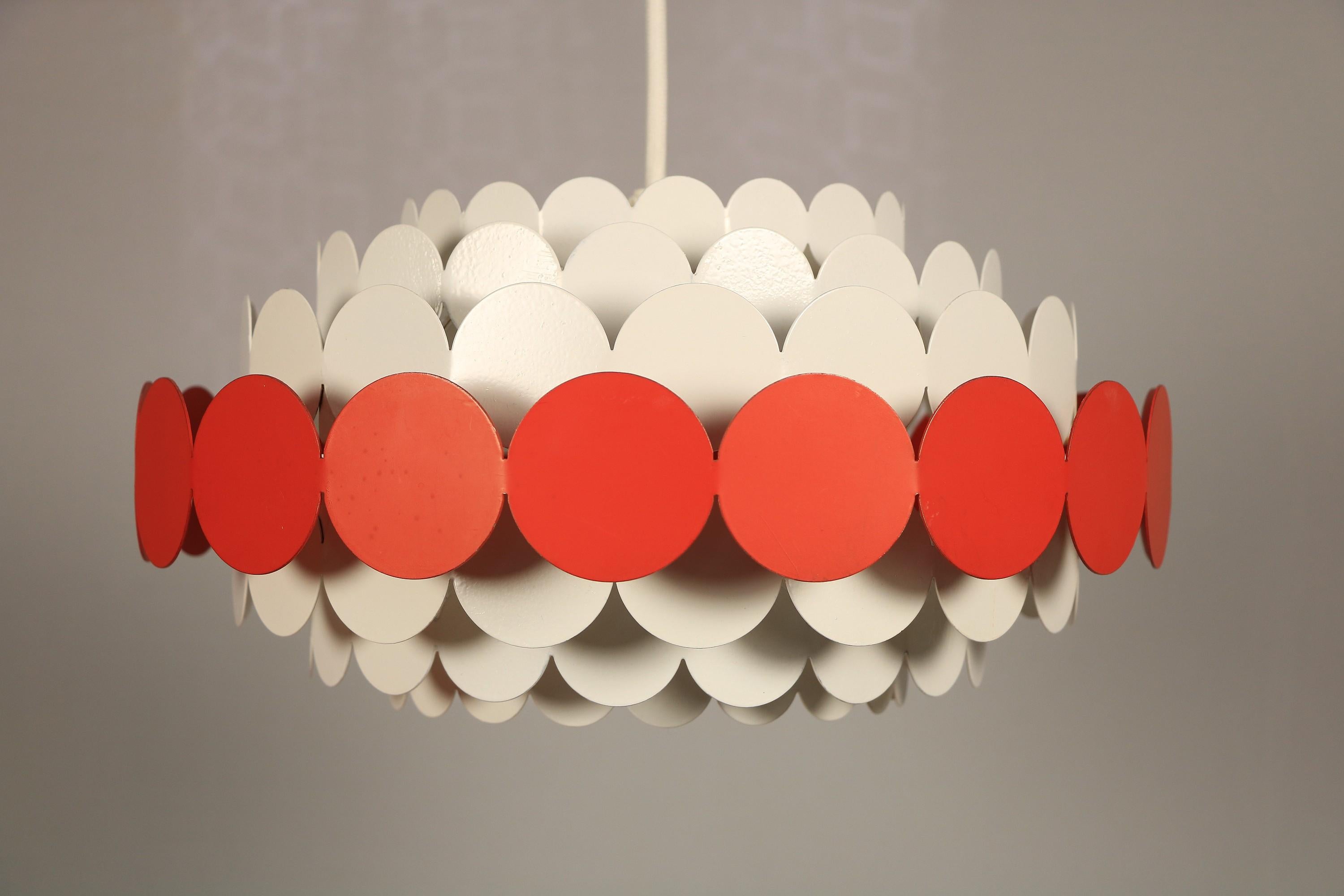 Rare pendant lamp made of many round metal plates.
Manufacturer: DORIA Leuchten

A great colorful spot in your interior.
 
Well preserved partly new painting of the white plates.
 
Slight chipping and partly minimal uneveness in the