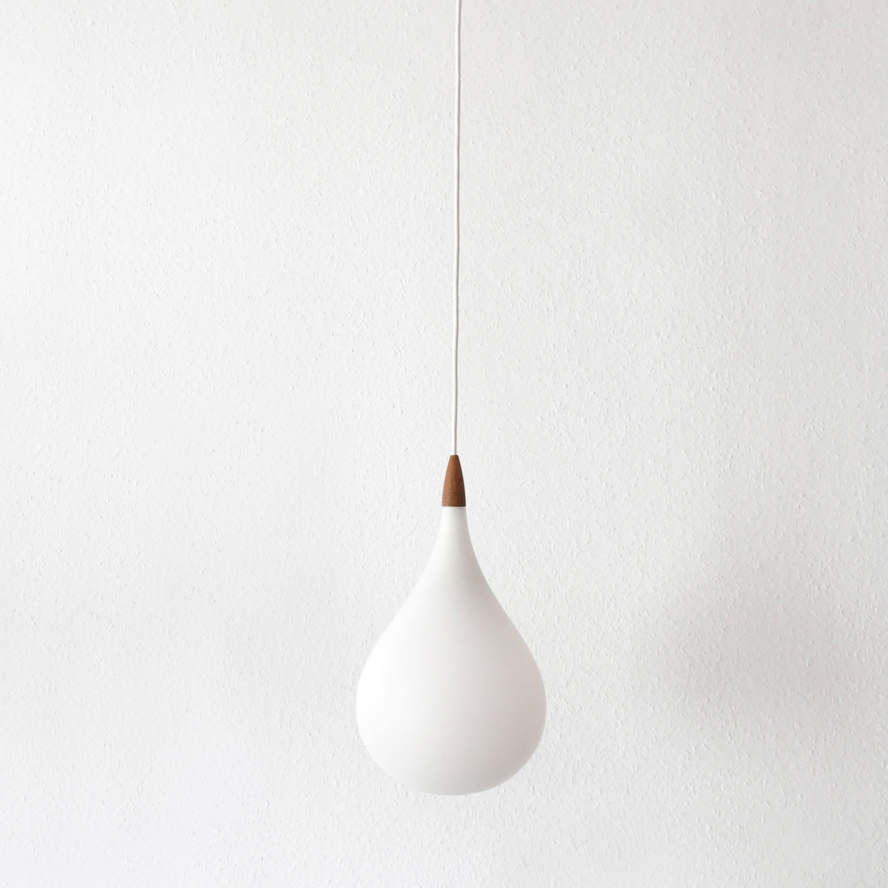 Exceptional and elegant pendant lamp Drop with one opaline glass shade in form of a water drop. Designed by Uno & Östen Kristiansson, 1957 for Luxus, Vittsjö, Sweden. The lamp is executed with one E27 screw fit bulb holder.