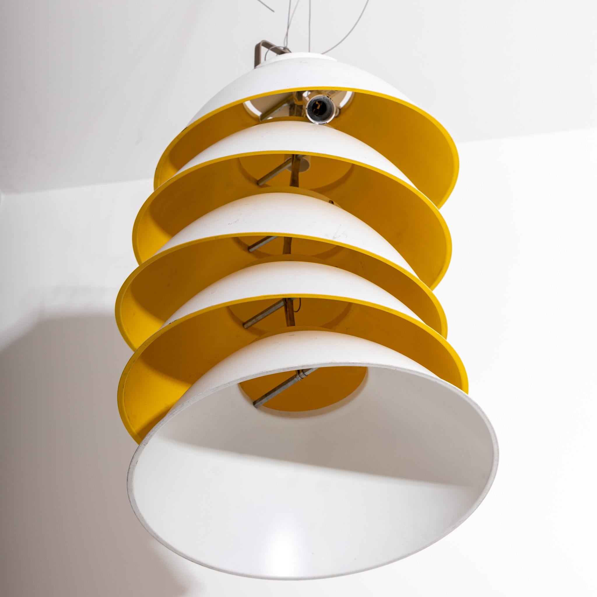Pendant lamp with five white lampshades and yellow inner side, which can be adjusted in height. Designed in 2007 by Axel Schmidt for Ingo Maurer.