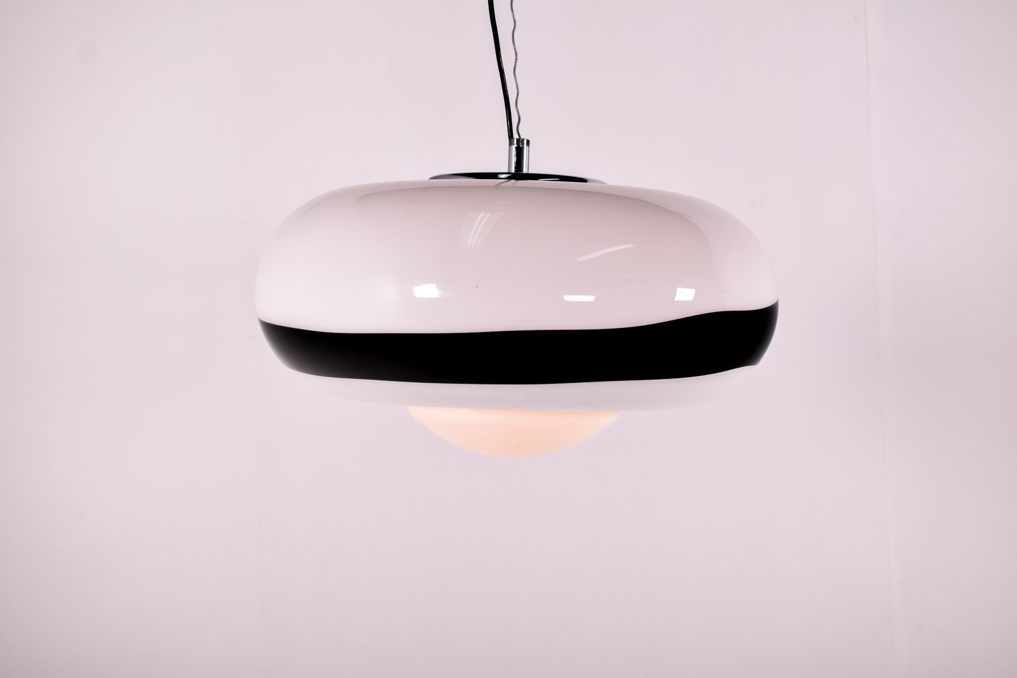 Harvey Guzzini pendant lamp. White and black acrylic globe lampshade. Chrome lamp socket holder. Chromed metal (iron) ring. White half round acrylic diffuser below.