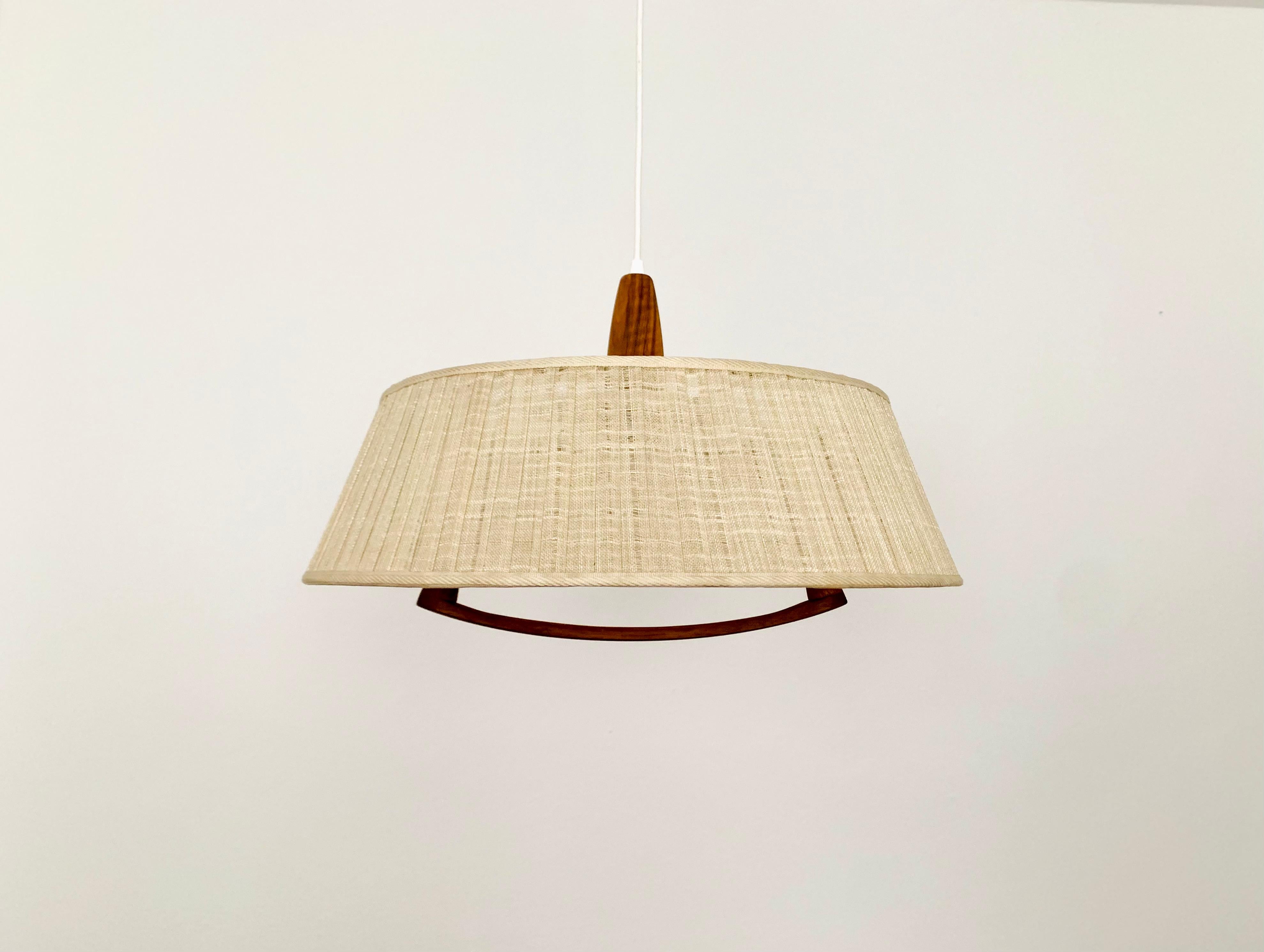 Exceptionally beautiful and large pendant lamp from the 1960s.
The design is very unusual.
The shape and the materials create a warm and very pleasant light.

Manufacturer: Temde

Condition:

Very good vintage condition with slight signs of