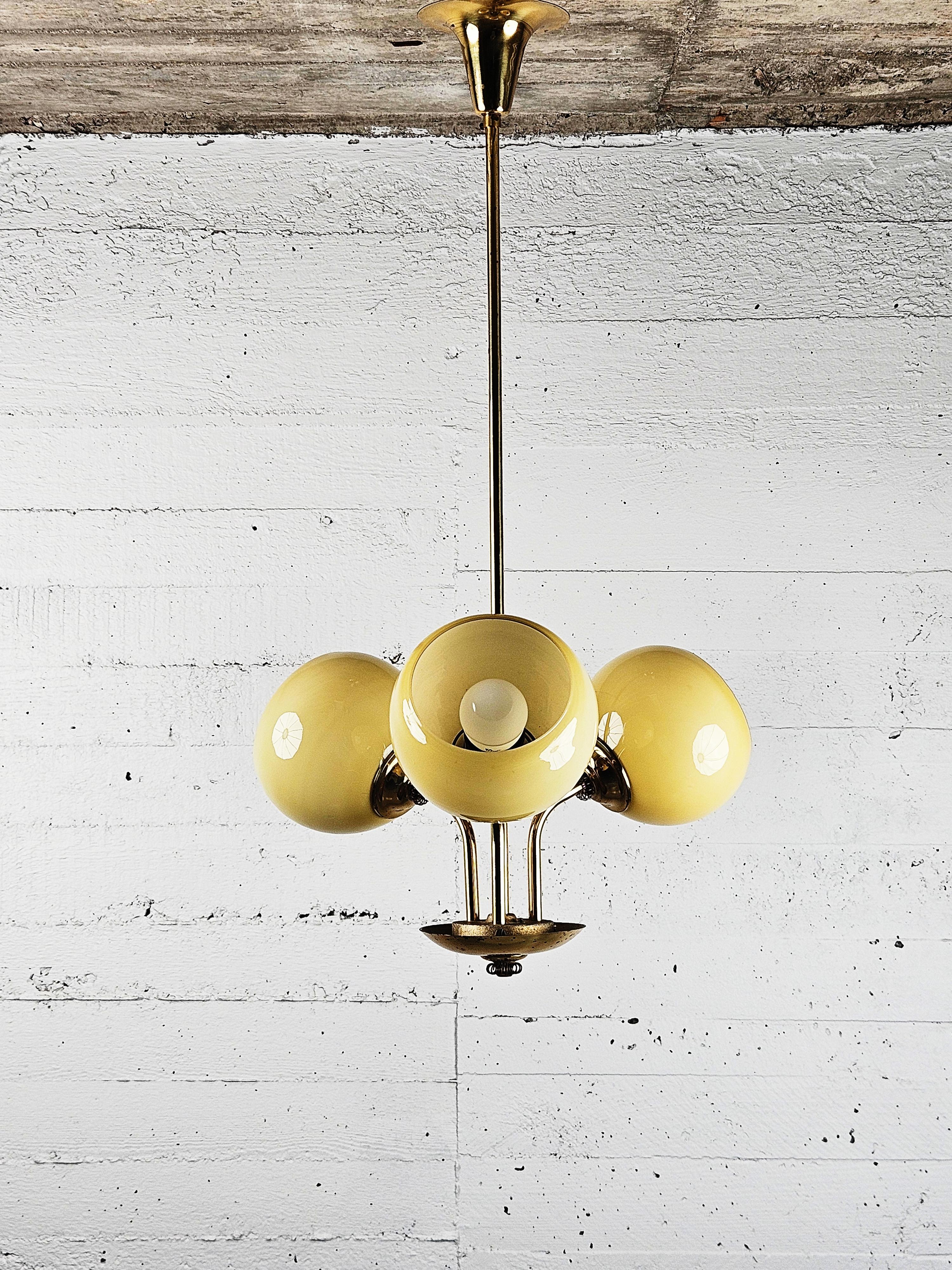 Great ceiling lamp in the style of Paavo Tynell. Made in Finland during the 1940s. 

Made in brass with beautiful details and opaline glass. 