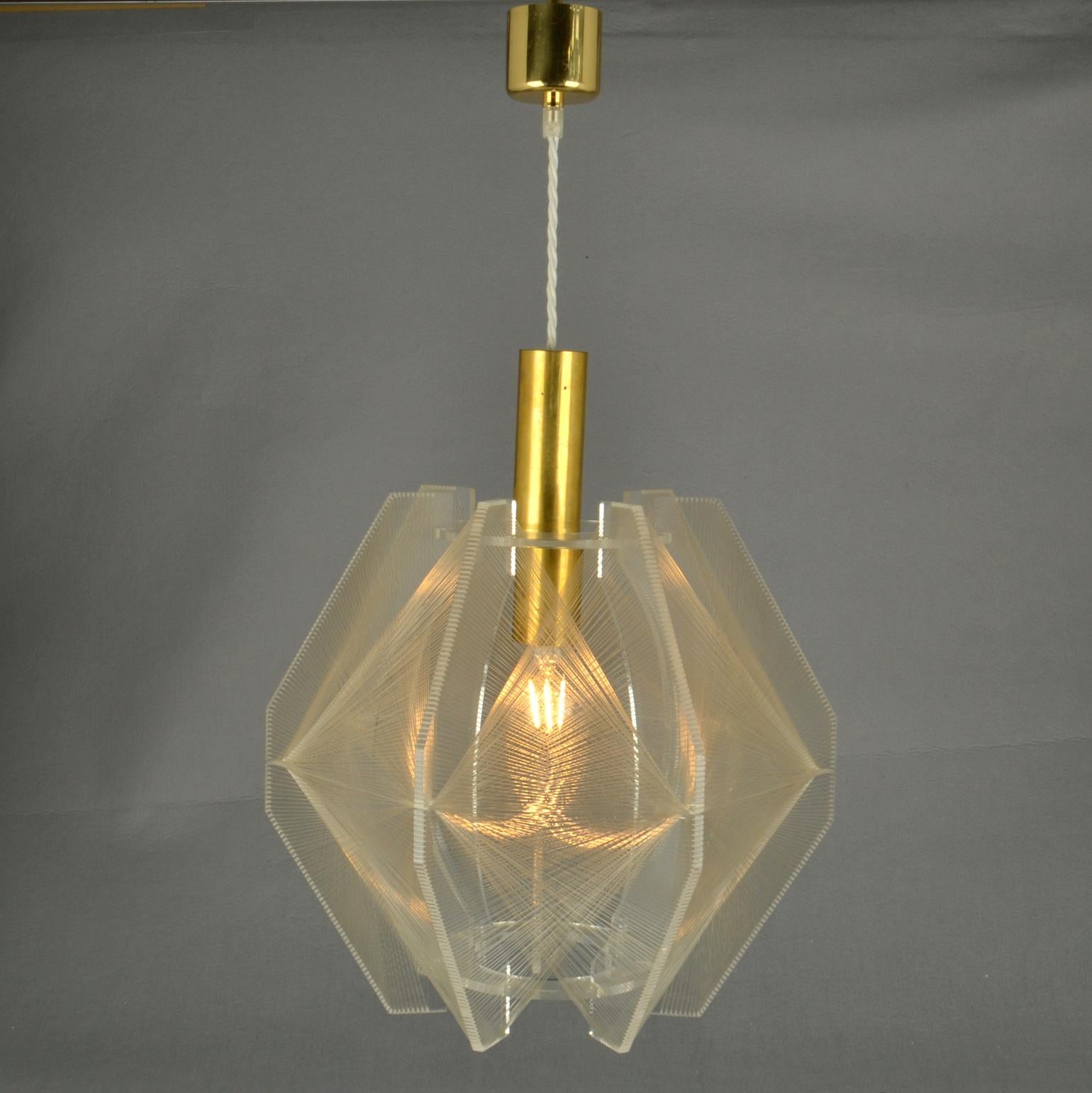 Sculptural lamp in angular shape of clear acrylic / Perspex and clear transparent wire accompanied brass internal fittings holder. The design is influenced by the pioneer, Avant Garde artist and sculptor Naum Gabo (1890–1977). 
These lamps are