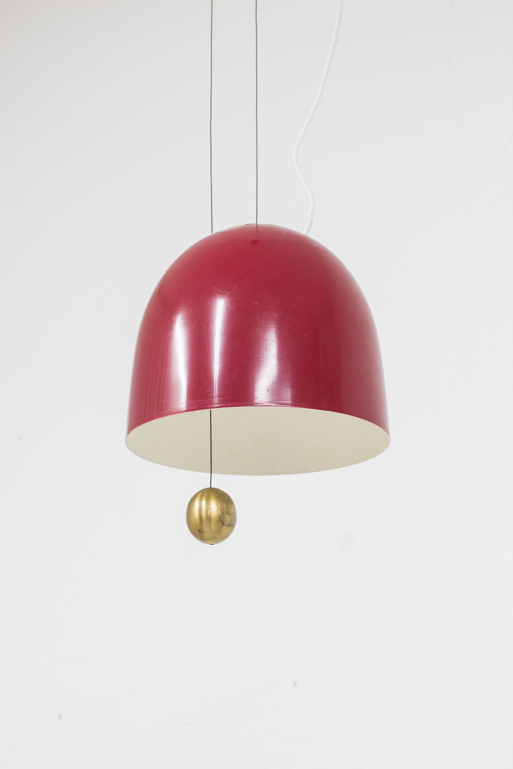 Rare ceiling lamp model T 177 designed by Hans-Agne Jakobsson. Produced by his own company during the 1950s. Made from red lacquered aluminum and brass. The brass ball act as a counterweight making the lamp seamlessly adjustable in height. Good