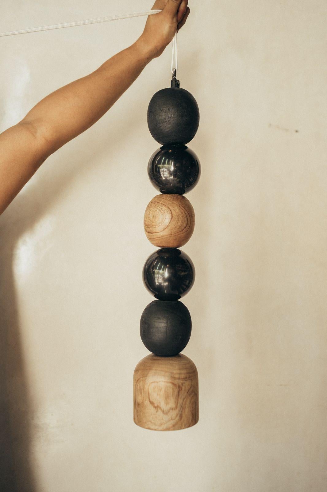 Pendant lamp of wooden, burned, natural and black marble balls by Daniel Orozco
Dimensions: D 13 x H 65 cm
Materials: Wood, Marble

All our lamps can be wired according to each country. If sold to the USA it will be wired for the USA for