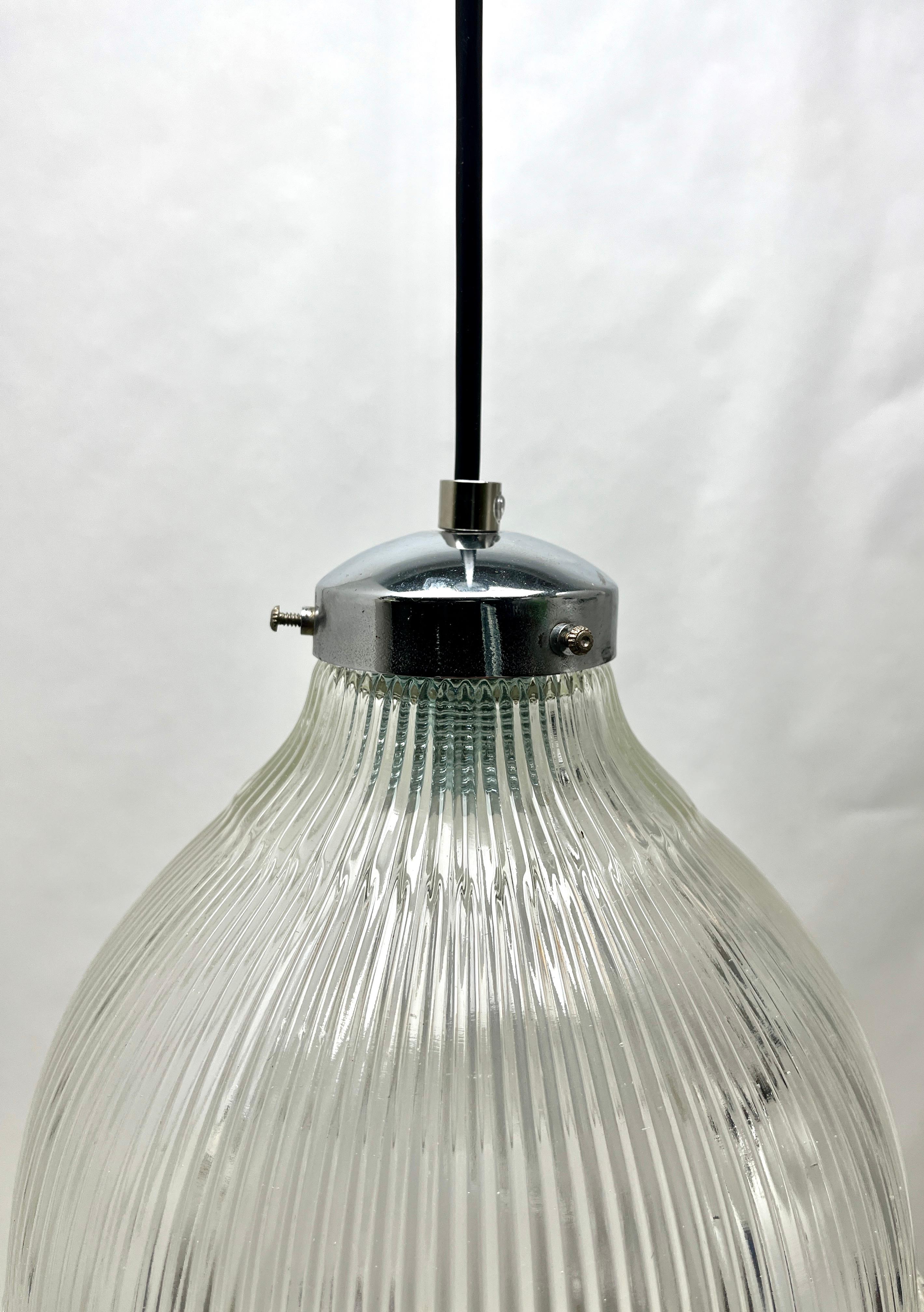 The lamp has a fitting on a chromed plate and holds a Corrugated glass shade 

In good condition and in full working order with standard new lamp fittings E27
With new wiring and has been checked carefully.
The lamp is provided with a screw