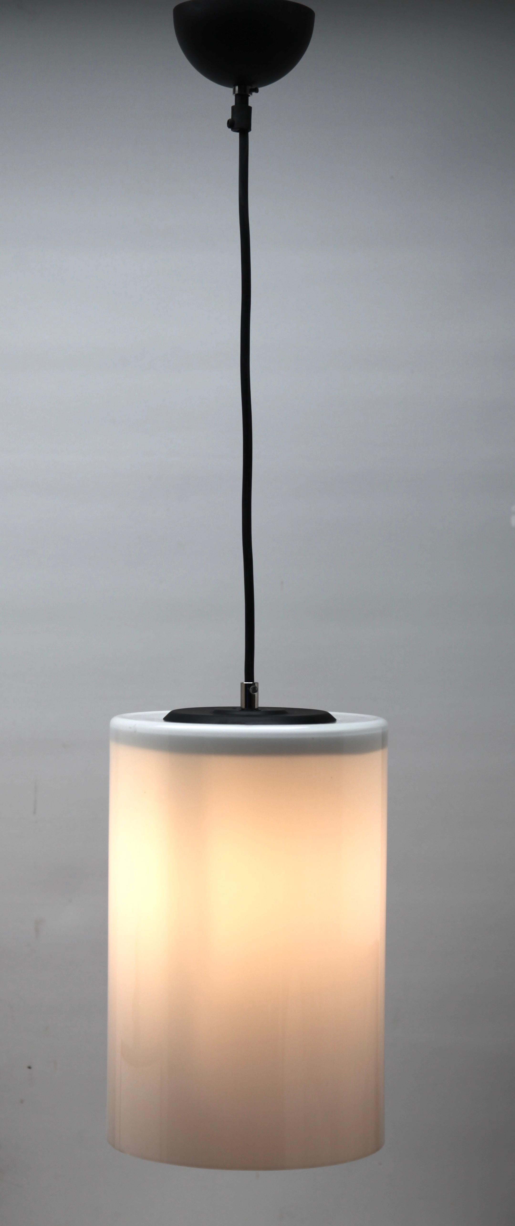 From the range by the Phillips Company, this centre-light is on an adjustable cable. 
The lamp has a fitting on a Black plate and holds a cylinder shape shade of opaline glass.

In good condition and in full working order with standard new lamp