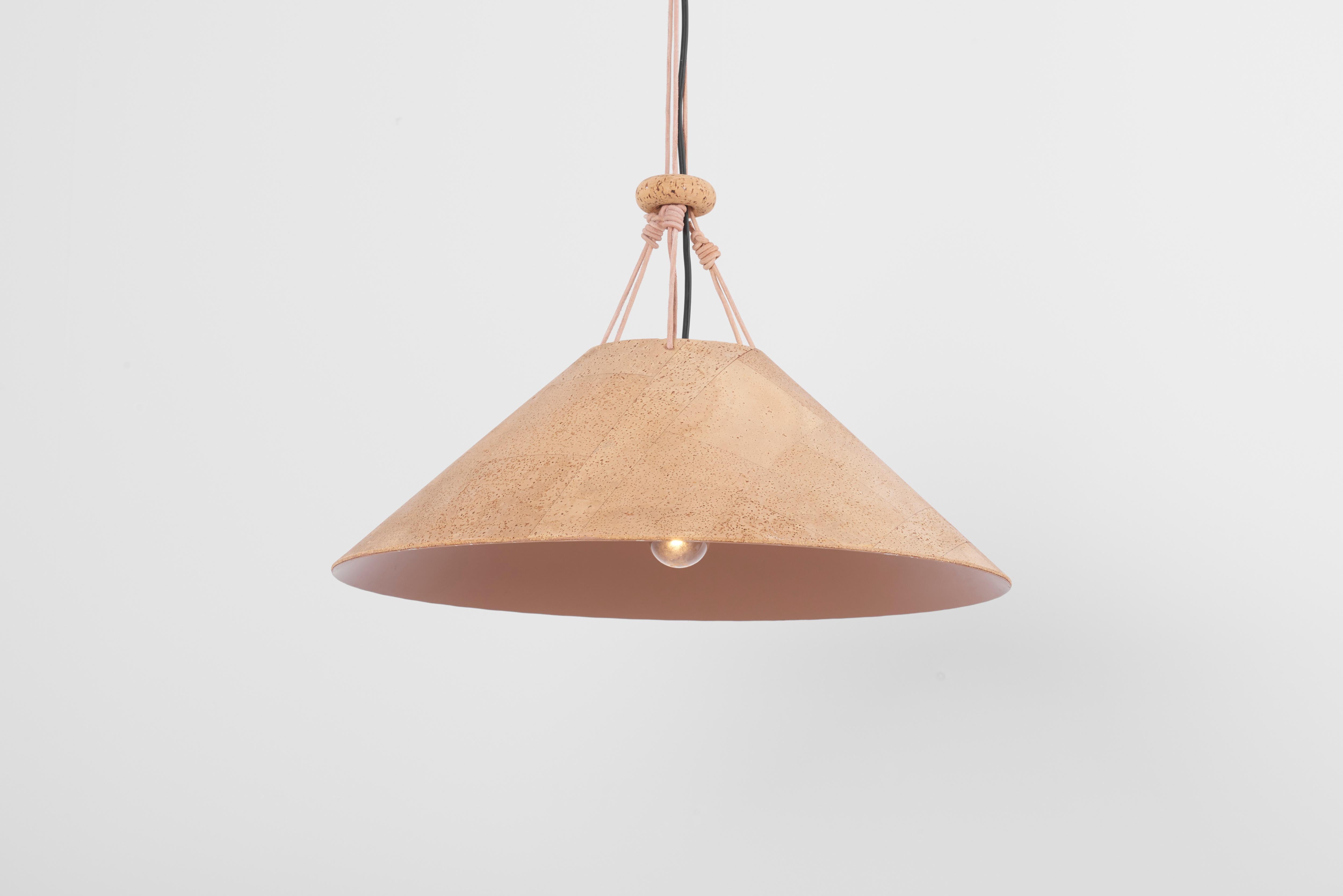 Rare pendant lamp in cork with leather strings by Wilhelm Zannoth for Ingo Maurer.

1 x E27 socket.

Please note: Lamp should be fitted professionally in accordance to local requirements.