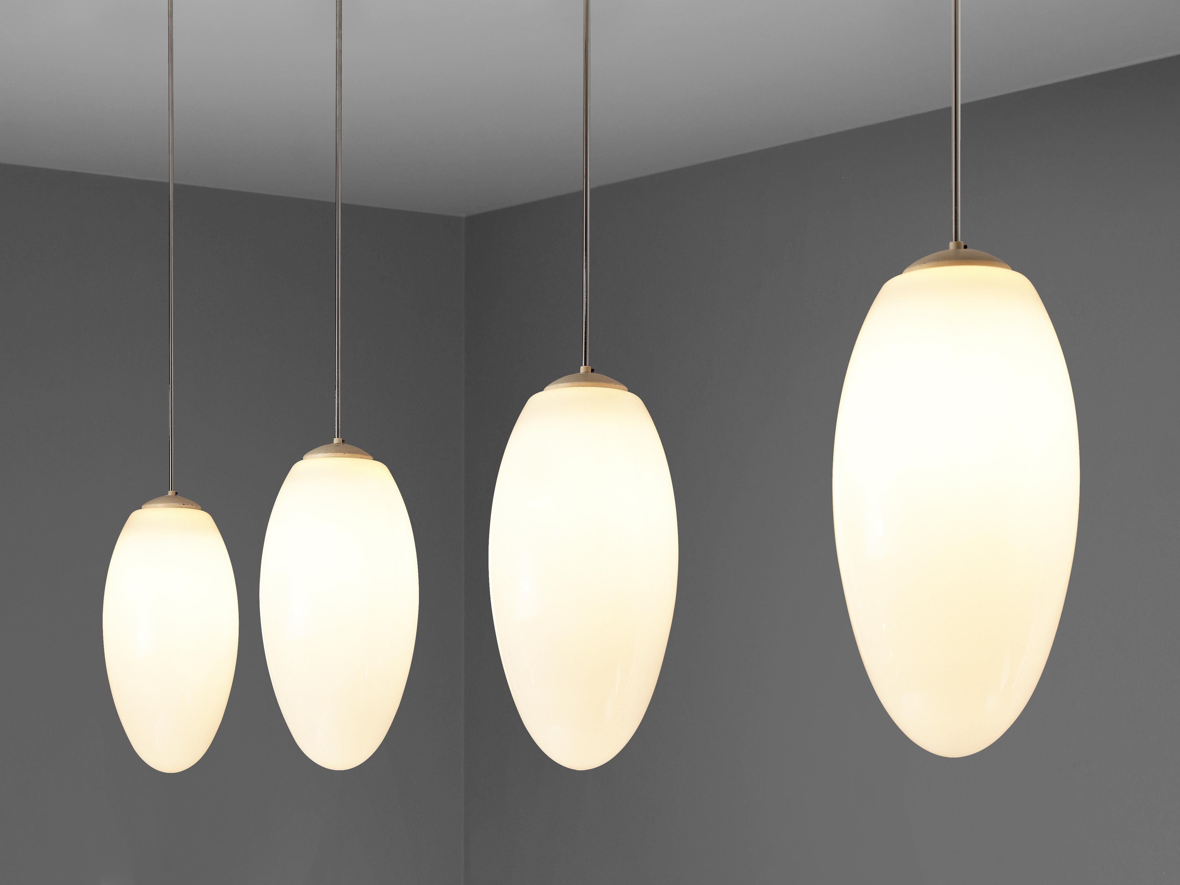 Pendant lamps, metal, opaline glass, plastic, Europe, 1970s

Beautiful in their design and displaying an understated elegance: minimalist pendant lamps adorned with drop-shaped glass shades. Suspended delicately from metal stems culminating in