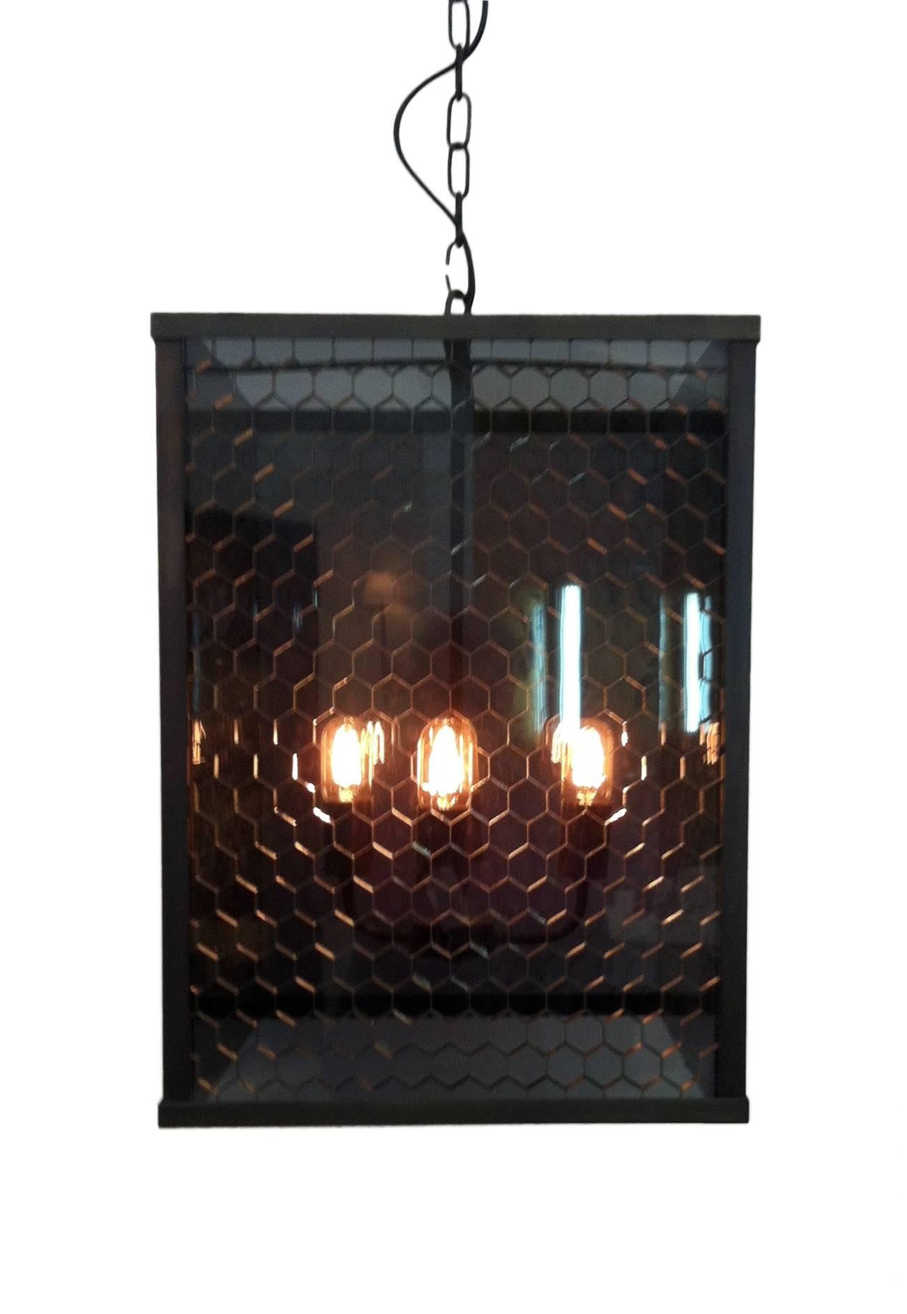 A clean, simple brass frame finished in Rustic bronze with grey-tinted rectangular honeycomb panels.
Lamp holders - 4x standard E26/27 
Made in Italy.