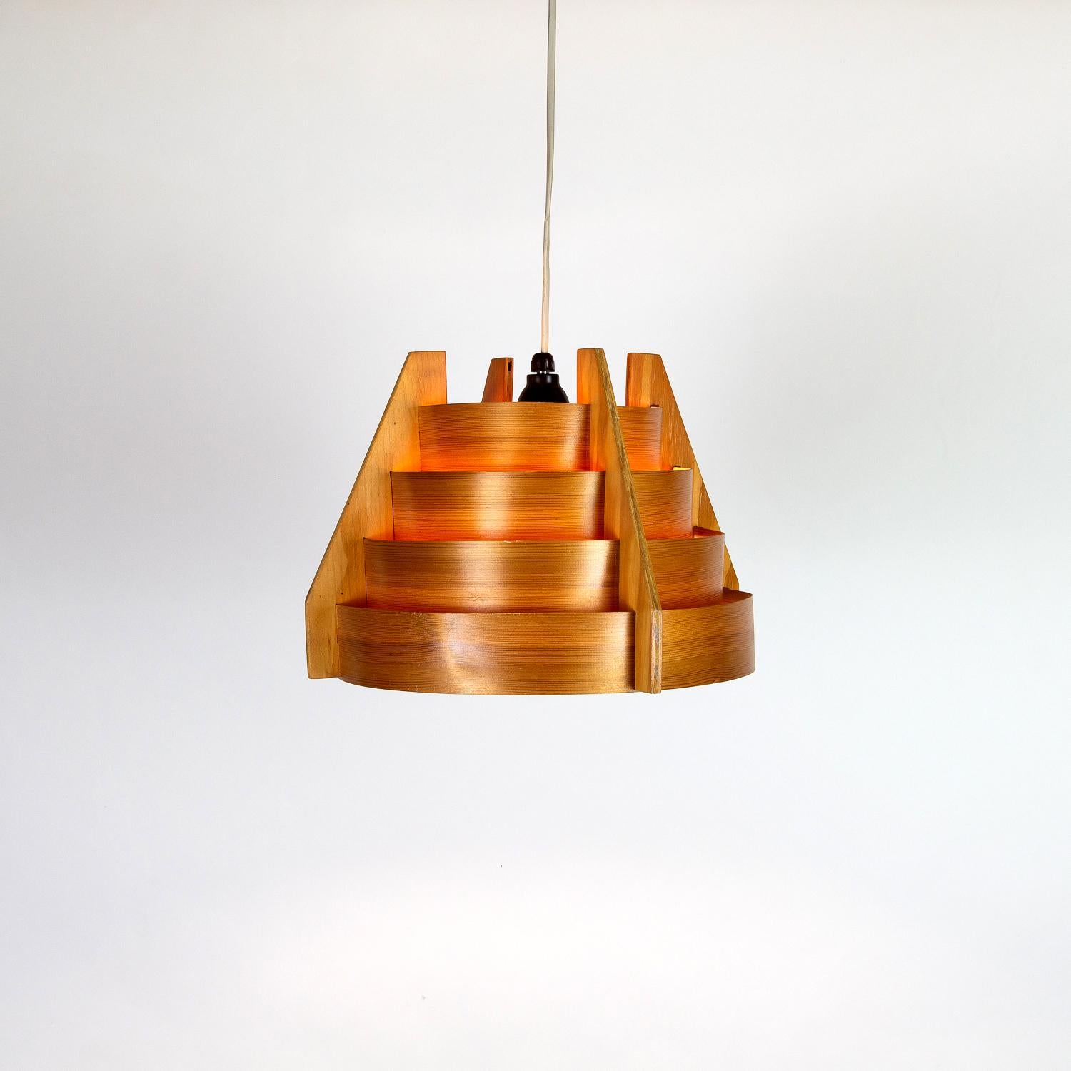 A midcentury wooden pendant light by Hans Agne Jakobsson for AB Markaryd, Sweden, 1960s. This design is a Scandinavian Classic, made from concentric pine circles creating warm, atmospheric light and hiding glare from the bulb.

   